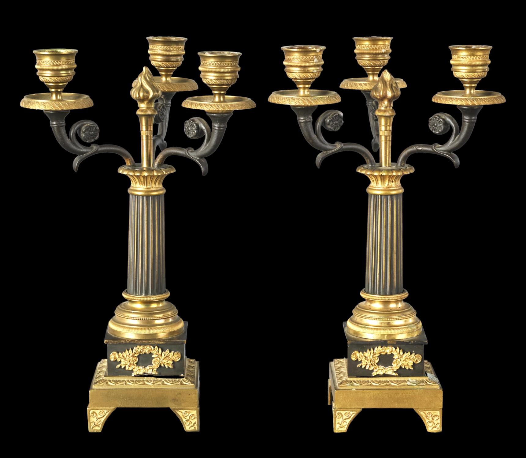A very fine pair of early 19th century Empire Period patinated & parcel gilt bronze three branch candelabra. Both showing a trio of finely cast scrolled & foliate shaped branches fitted with richly gilded nozzles & flattened bobeches, atop reeded