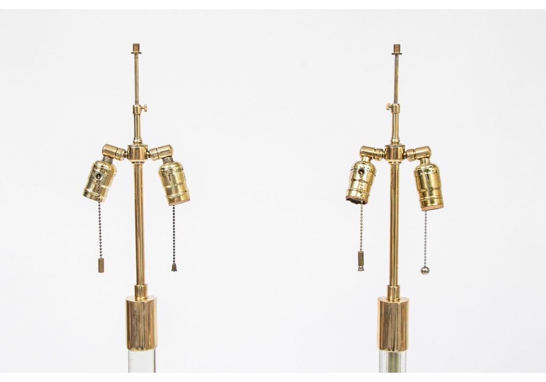 Fine pair of midcentury glass column floor lamps in exceptional condition by Hansen. Reminiscent of the designs of iconic American lighting designer Cedric Hartman, the pair are notable for their material as well as their presentation. The pair have