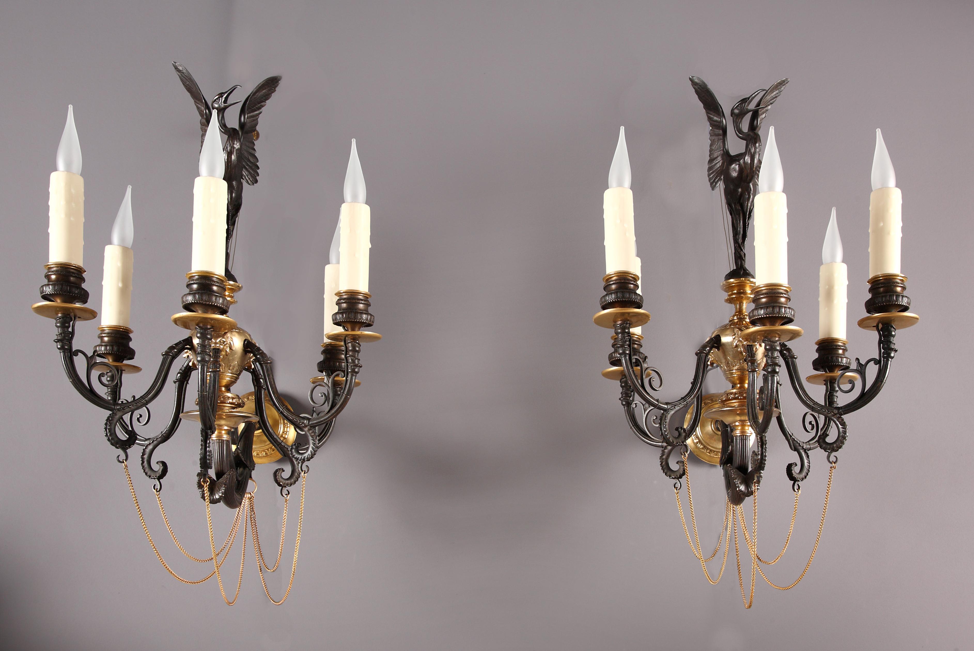 A pair of neo-Greek wall-light sconces executed in two patina bronze attributed to F. Barbedienne. The central up-turned foliage stem, surmounted by a Greek style vase, ornated in relief with lion muzzles, issuing five light arms, joined by fine