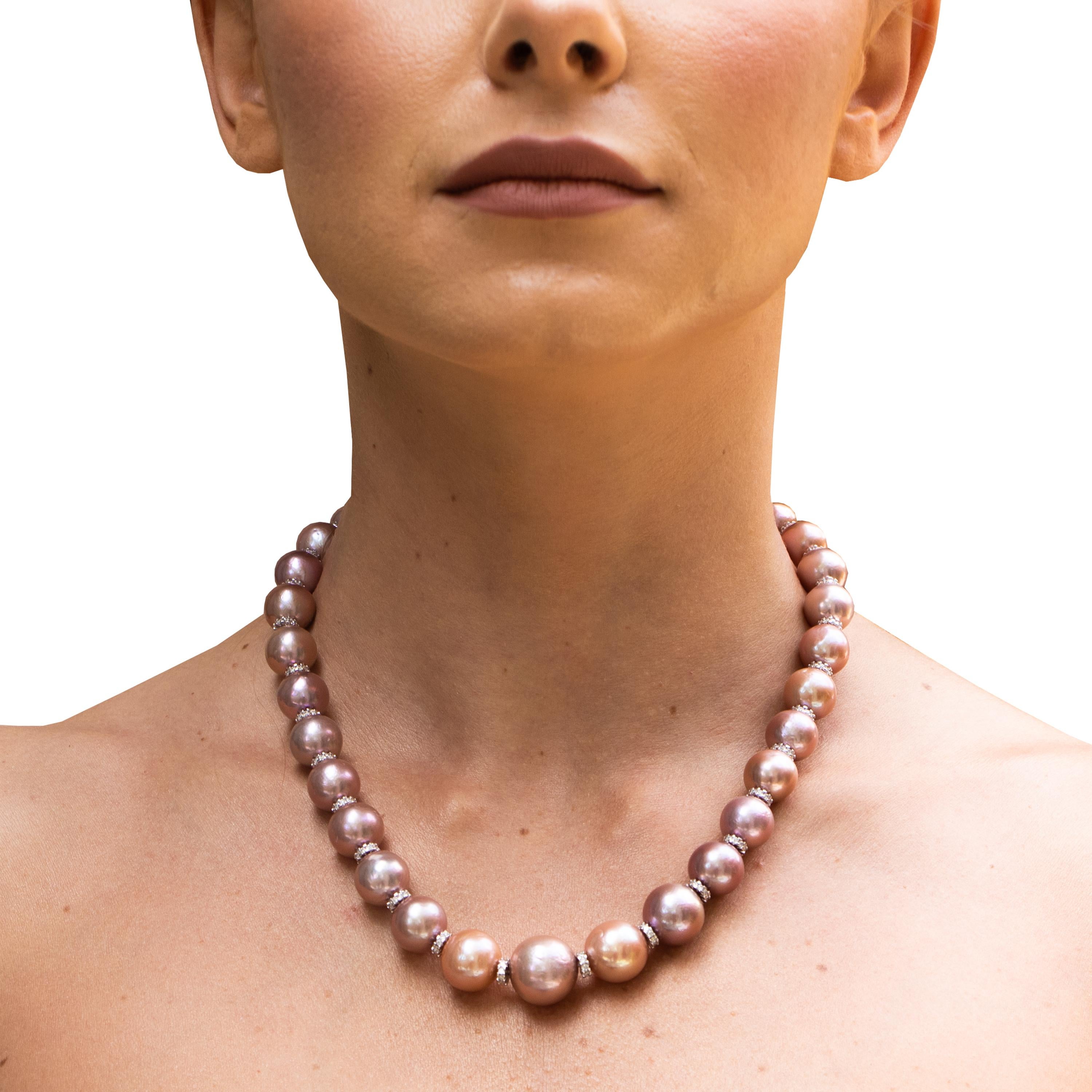 Stunning pink pearl necklace with diamond rondelles and a beautiful clasp. It's an easy show stopper. 
Very Fine Pink Pearls = 11-16mm
Length = 19 Inches