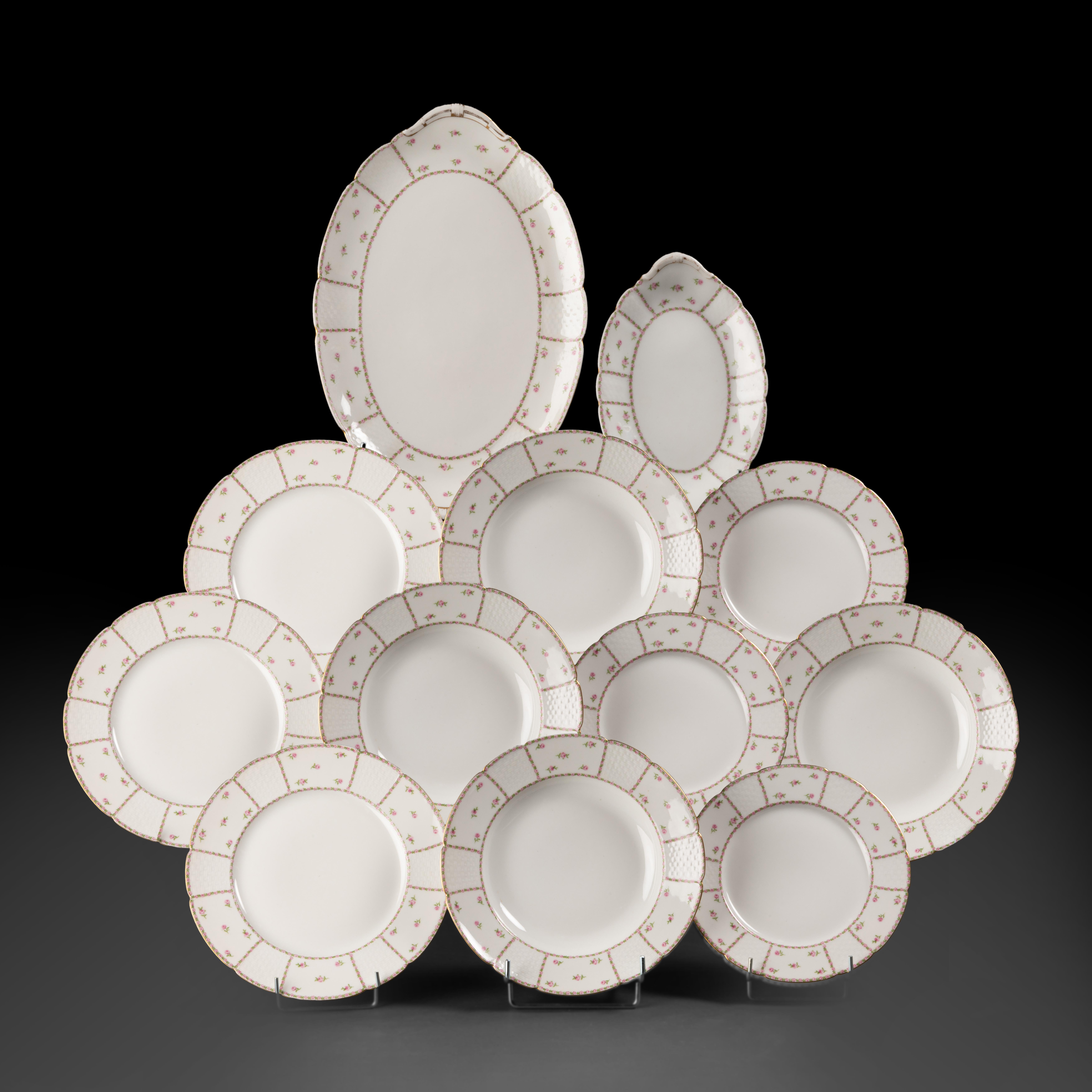 Limoges porcelain tableware by GOA. Very white fine porcelain decorated with small roses and basket weave motif with a gold rim.

Dinner plates (25 cm) - 12x
Soup plates (25 cm) - 9x
Dessert plates (21 cm) - 11
Oval serving dish (37x24 cm) -