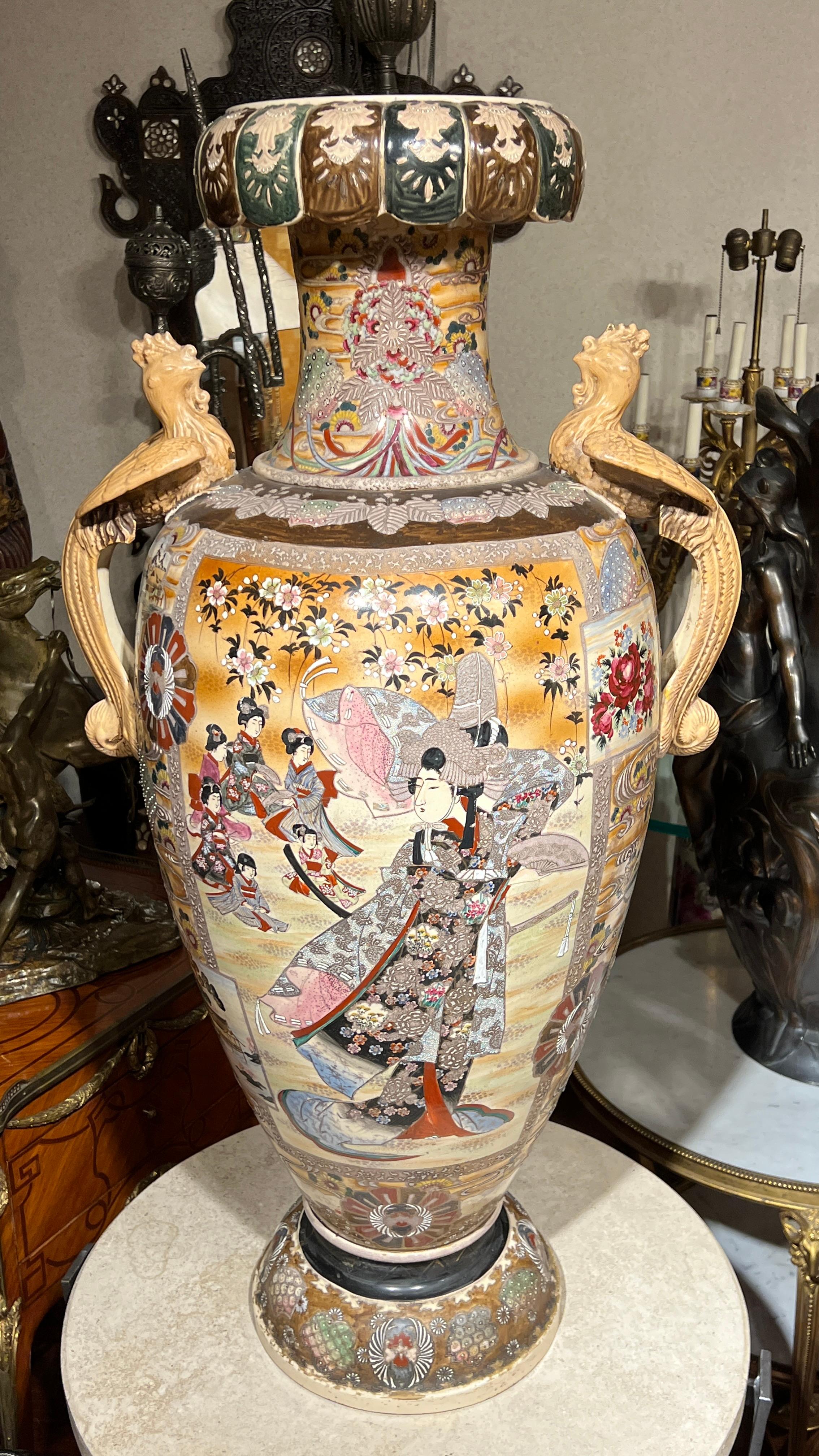 A very fine quality monumental Japanese vase depicting Samurai on one side and distinguished female and her attendants on reverse, particularly unique for its very prominent stylized bird handles.  42 inches tall and 22 inches across.
Great Quality