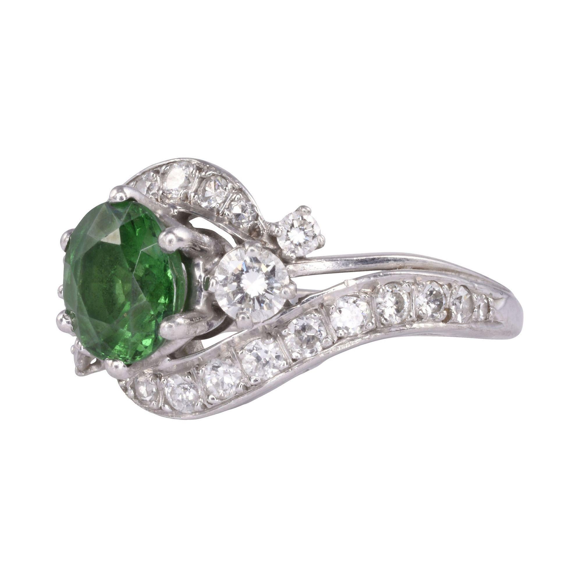 Estate very fine quality tsavorite diamond platinum ring. This platinum ring features a 1.35 carat center tsavorite garnet with very fine quality and color. It is accented with .68 carat total weight of diamonds having VS-SI clarity and H-I color.