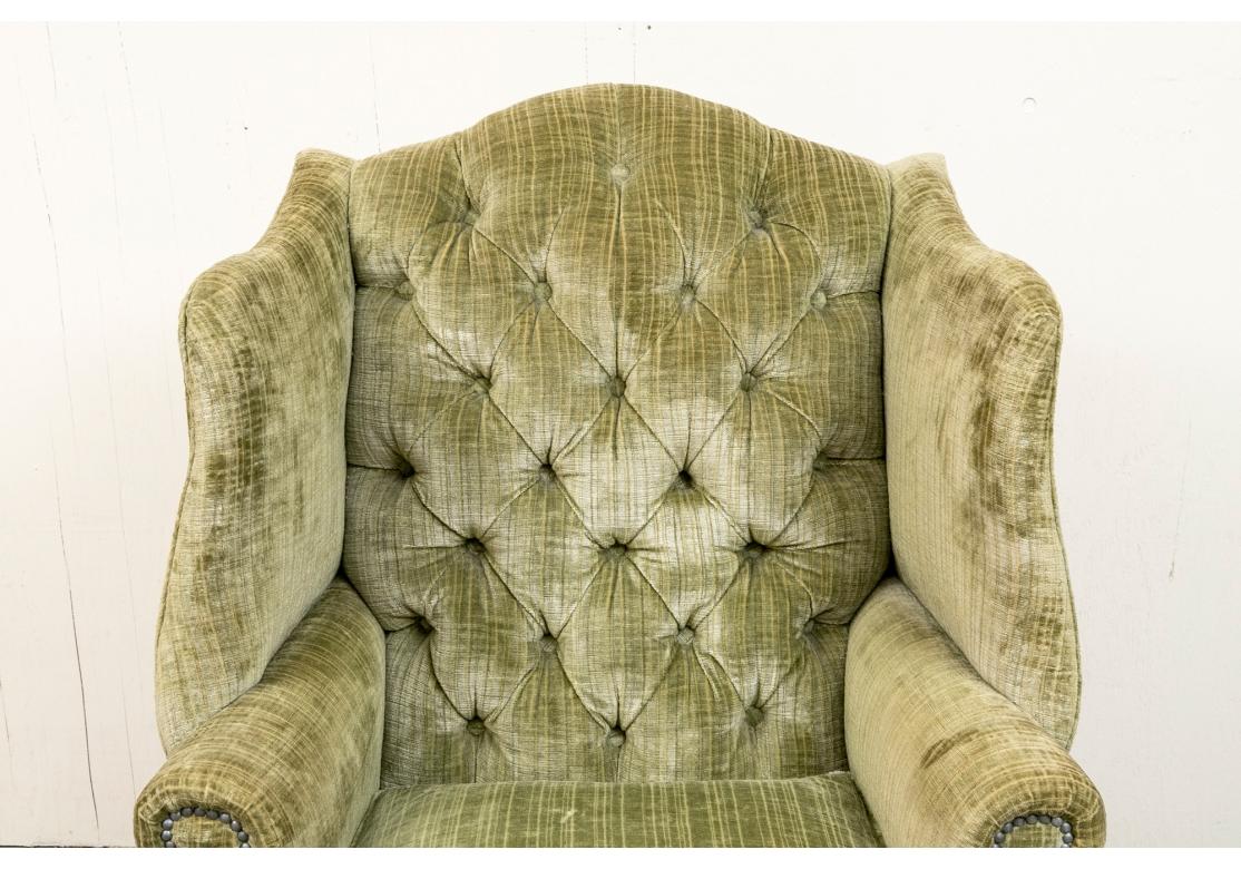 A very well made and large Tuft Back Wing Chair with fine form and great comfort. Upholstered in a handsome striped Velvet with a nice soft hand and having flat-panel arms bearing Conforming Nail-Head trim. 

The Chair measures 46” high by 33.5”