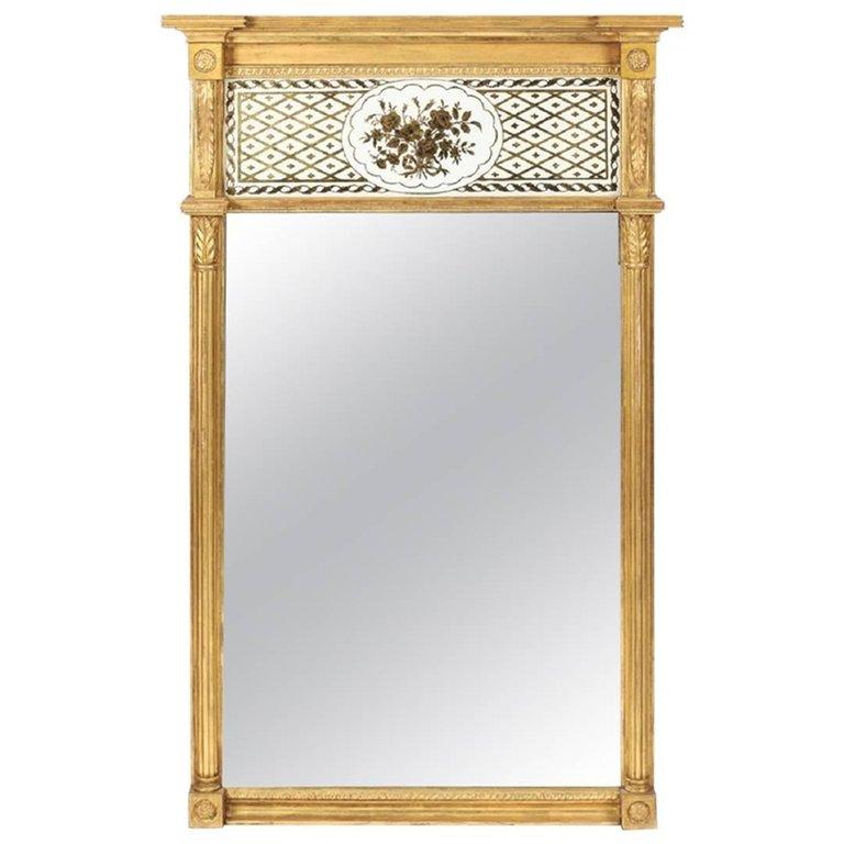 Vertical mirrors such as this one give real presence to any space lucky enough to have them. They are especially effective in foyers, living and dining rooms. This mirror's frame is hand made of finely carved, gilded, and gold leafed (on gesso)