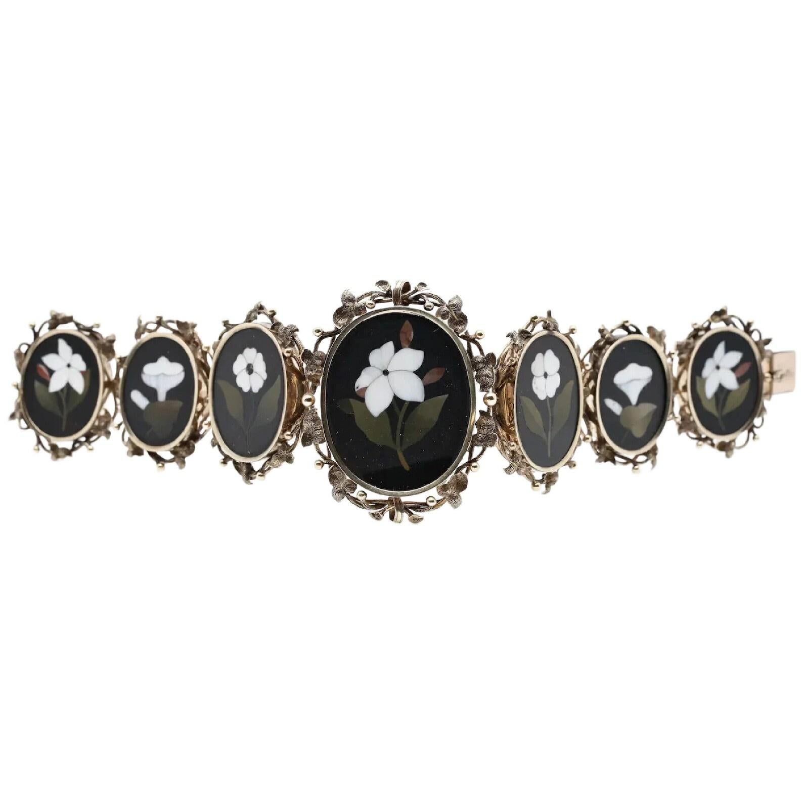 A beautiful victorian period floral motif pietra dura bracelet from Florence Italy circa 1875. Featuring beautifully inlaid Lilies of the Valley and Forget me Not's inlaid in various shades of marble and agate. The uncommonly ornate mounting