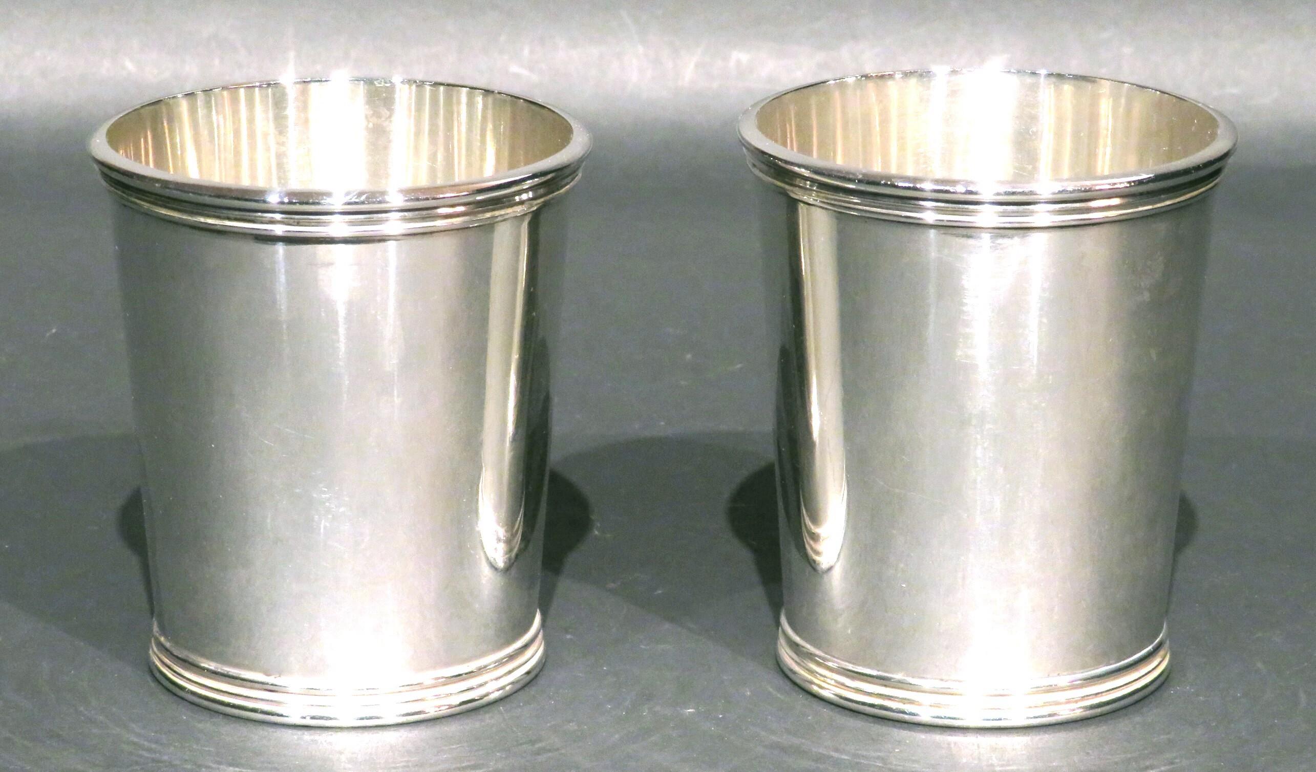 A very good and heavy pair of sterling silver mint julep cups, their rims & bases decorated with reeded detail, their interiors showing traces of a faint gilt wash, their undersides stamped STERLING and bearing model number 895 together with makers