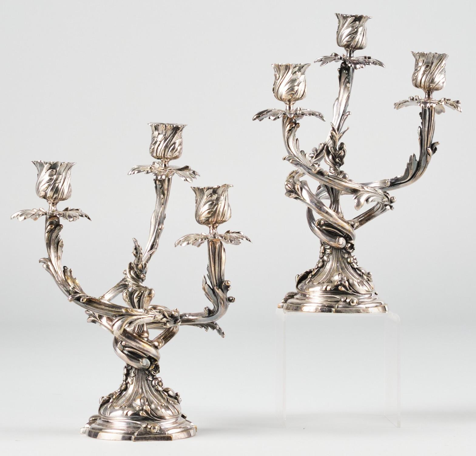 A very handsome pair of 19th century silvered bronze 3 branch candelabra in the style of Louis XV. Both showing a trio of richly cast foliate shaped branches fitted with detachable tulip shaped nozzles atop leafy bobeches, rising from