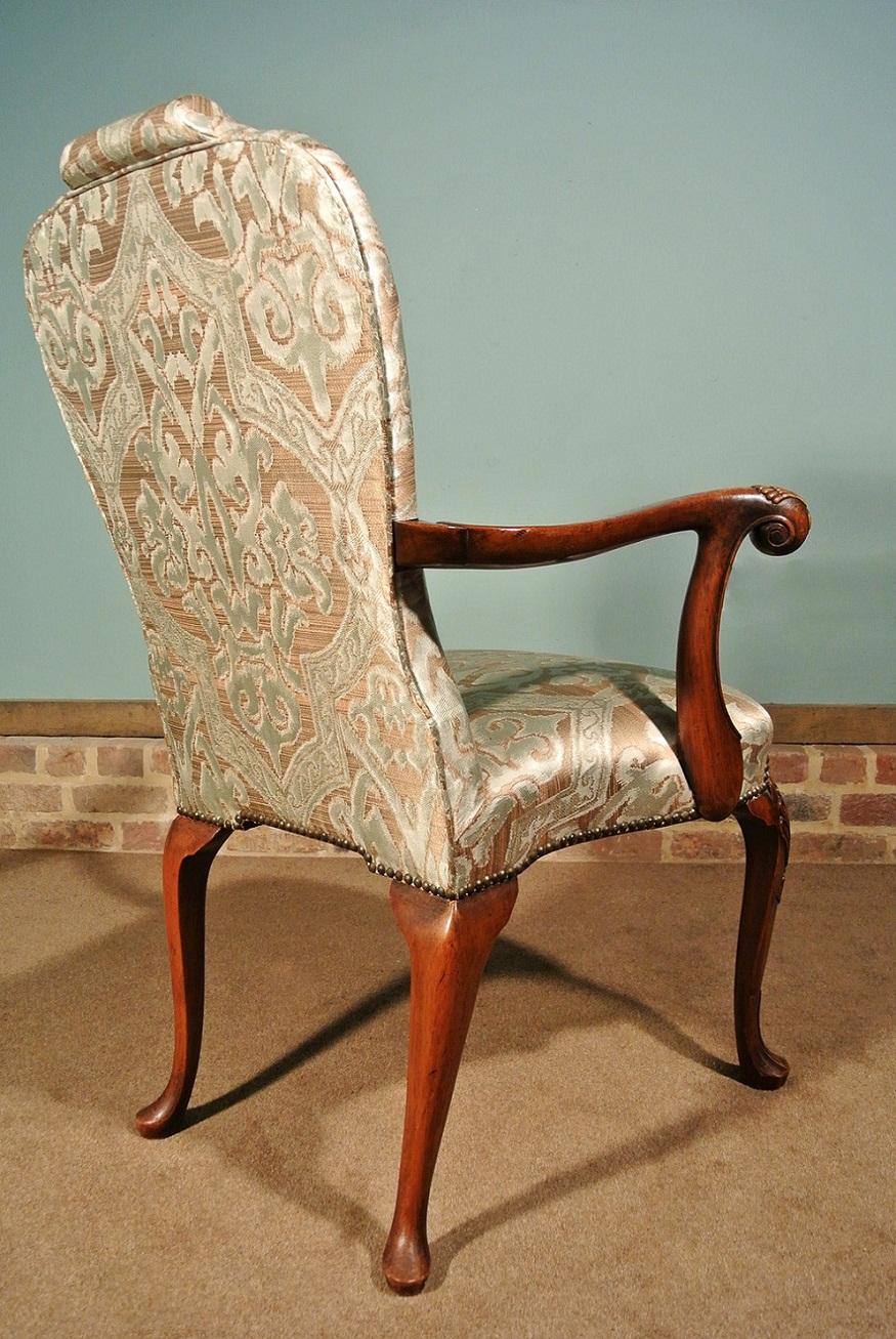 A particularly good Victorian chair brimming with Queen Anne details including elegant shell carved cabriole legs to the front with drop bell husks and carved shoulders. The rear legs are cabriole also and all four legs terminate in fine webbed