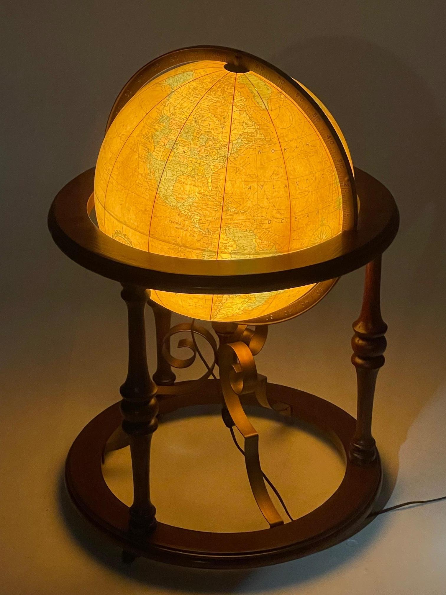 A beautiful large glass globe that illuminates and is contained in a handsome walnut and iron stand. Large enough to be freestanding on the floor. By Repolo Gle. 
Globe itself is 16 diameter.