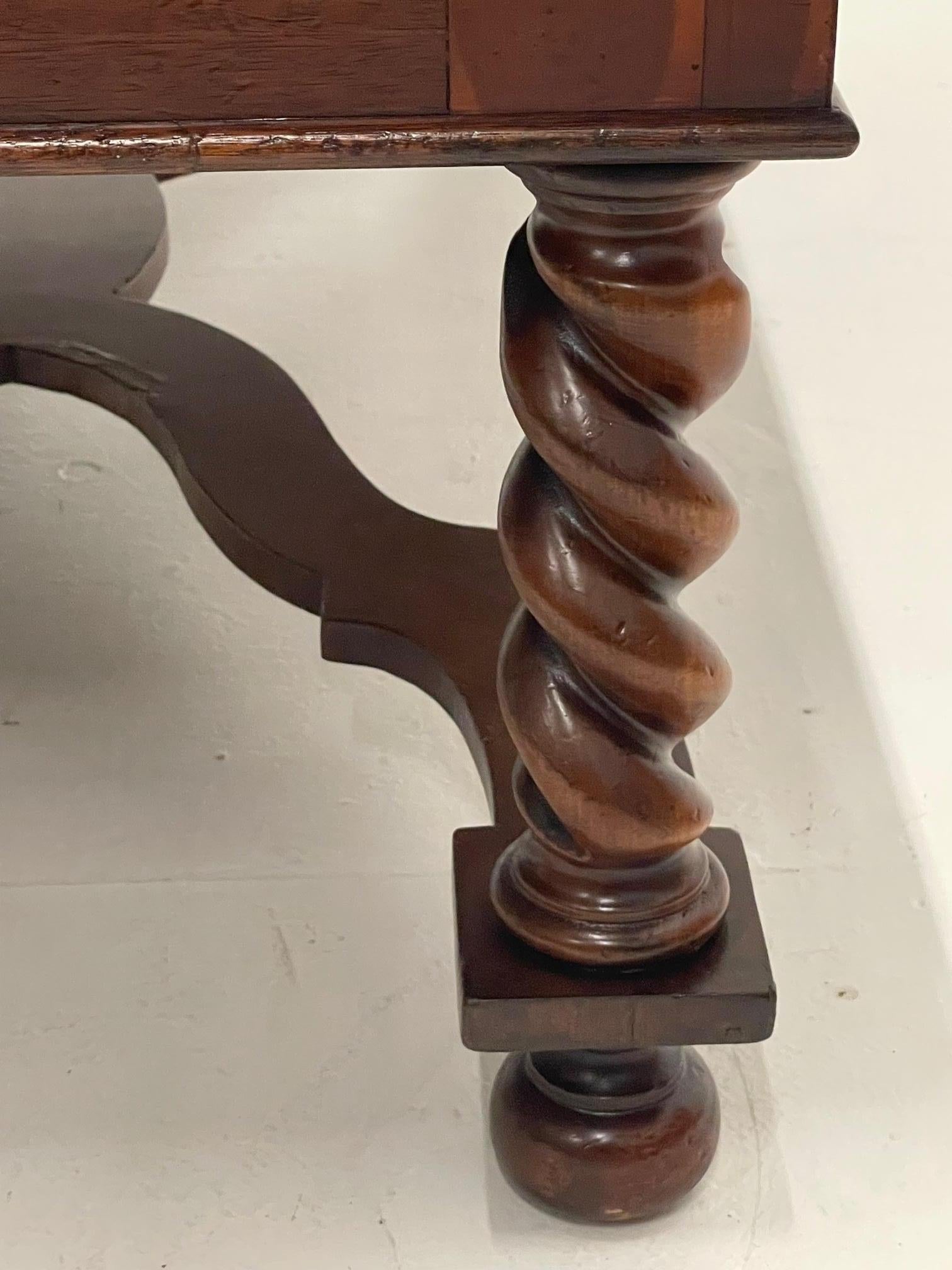 Very handsome rectangular walnut coffee table having stunning oyster veneer edging around the periphery of the top and masculine barley twist legs and striking carved wood stretcher beneath.