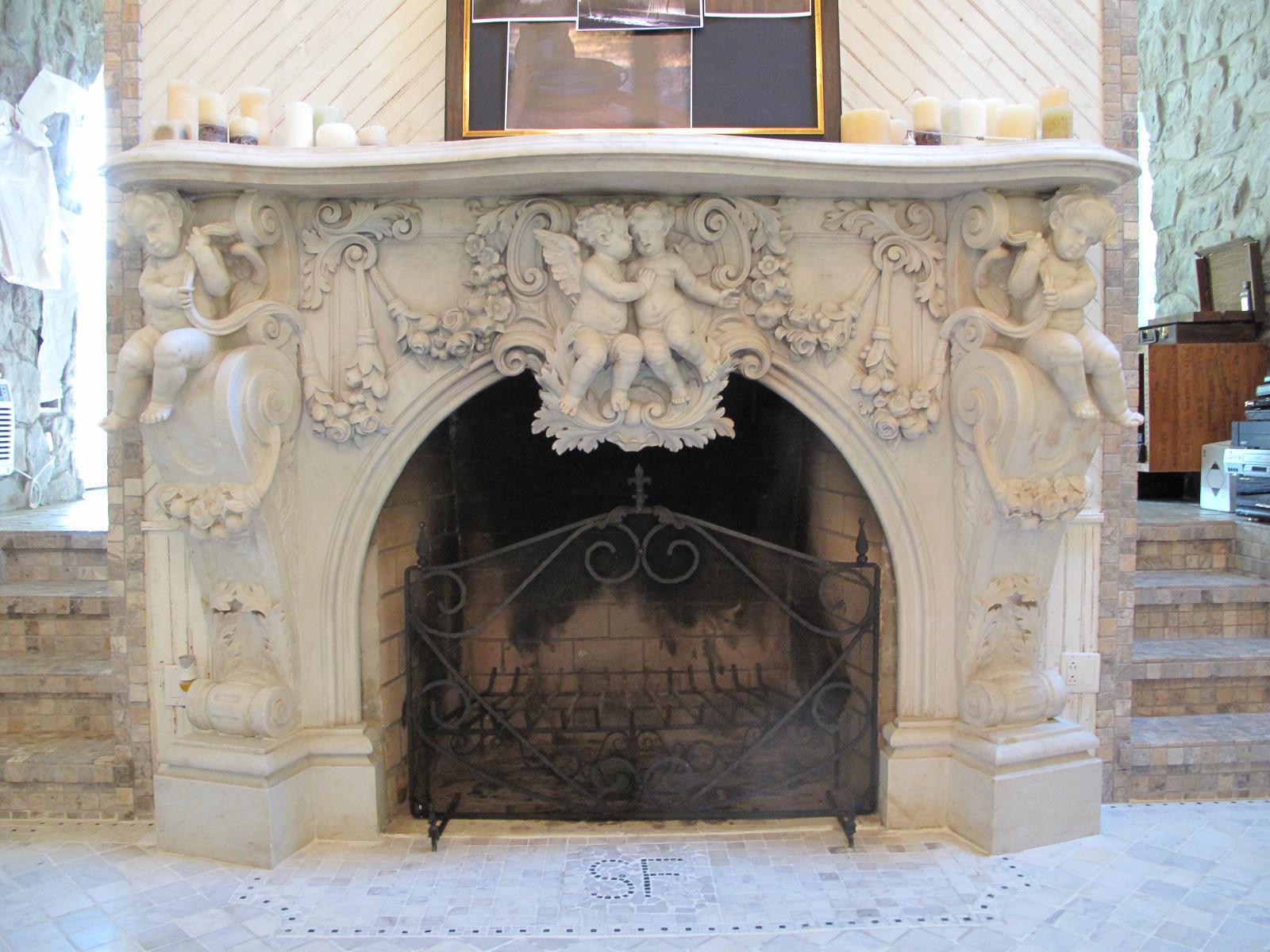Very Important and large finely carved Italian white Carrara marble fireplace mantel in the grand Baroque style. This mantel (fireplace) is profusely carved throughout by the finest Italian craftsman of the period, It features beautifully carved