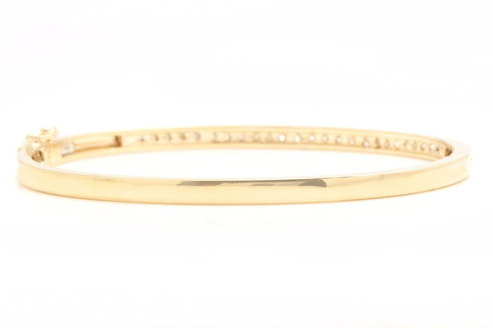 Very Impressive 1.40 Carats Natural Diamond 14K Solid Yellow Gold Bangle Bracelet 

Suggested Replacement Value: Approx. $6,000.00

STAMPED: 14K

Total Natural Round Diamonds Weight: Approx. 1.40 Carats (color G-H / Clarity SI)

Bangle Wrist Size