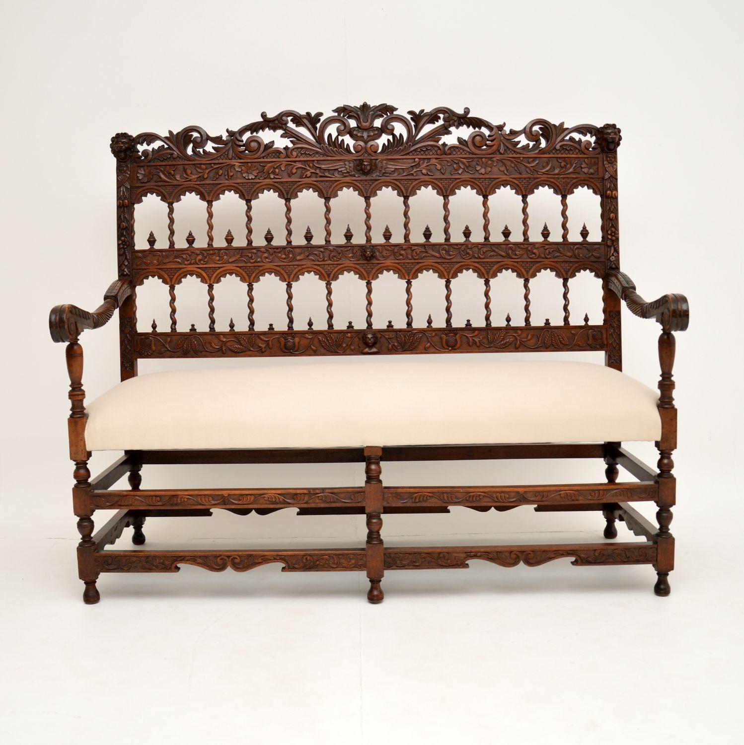 A stunning antique settee, finely carved from solid mahogany or possible walnut. This dates from around the 1840-60’s period, and is a most impressive work of art.

The profuse carvings depict floral motifs, lions heads, angels, pierced Moorish