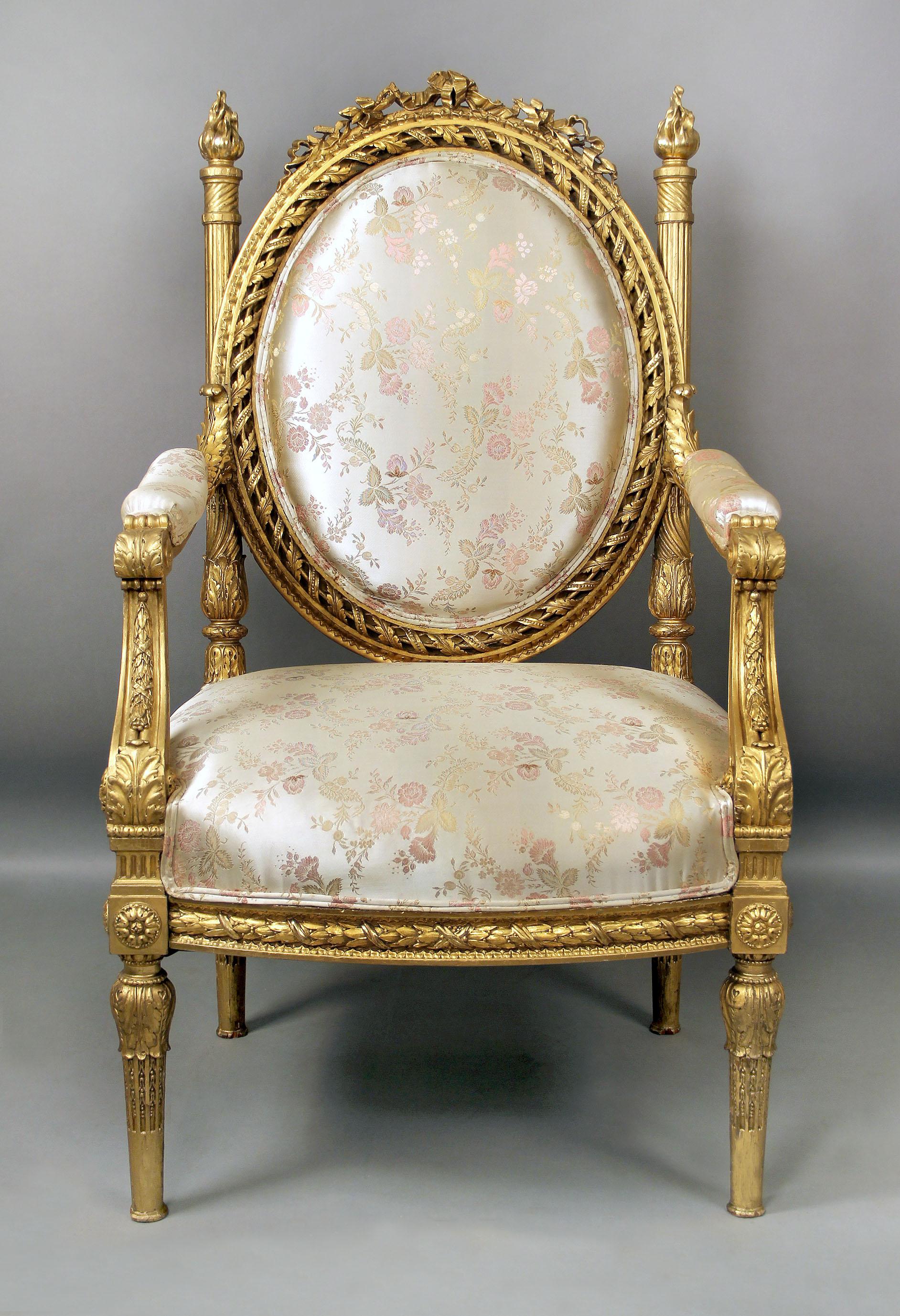 A large and very impressive late 19th century Louis XVI style giltwood Throne chair.

The oval backrest finely carved with pierced spiral frame suspended from two spiral-fluted spindles leading to flames, the seat rail carved with laurels and
