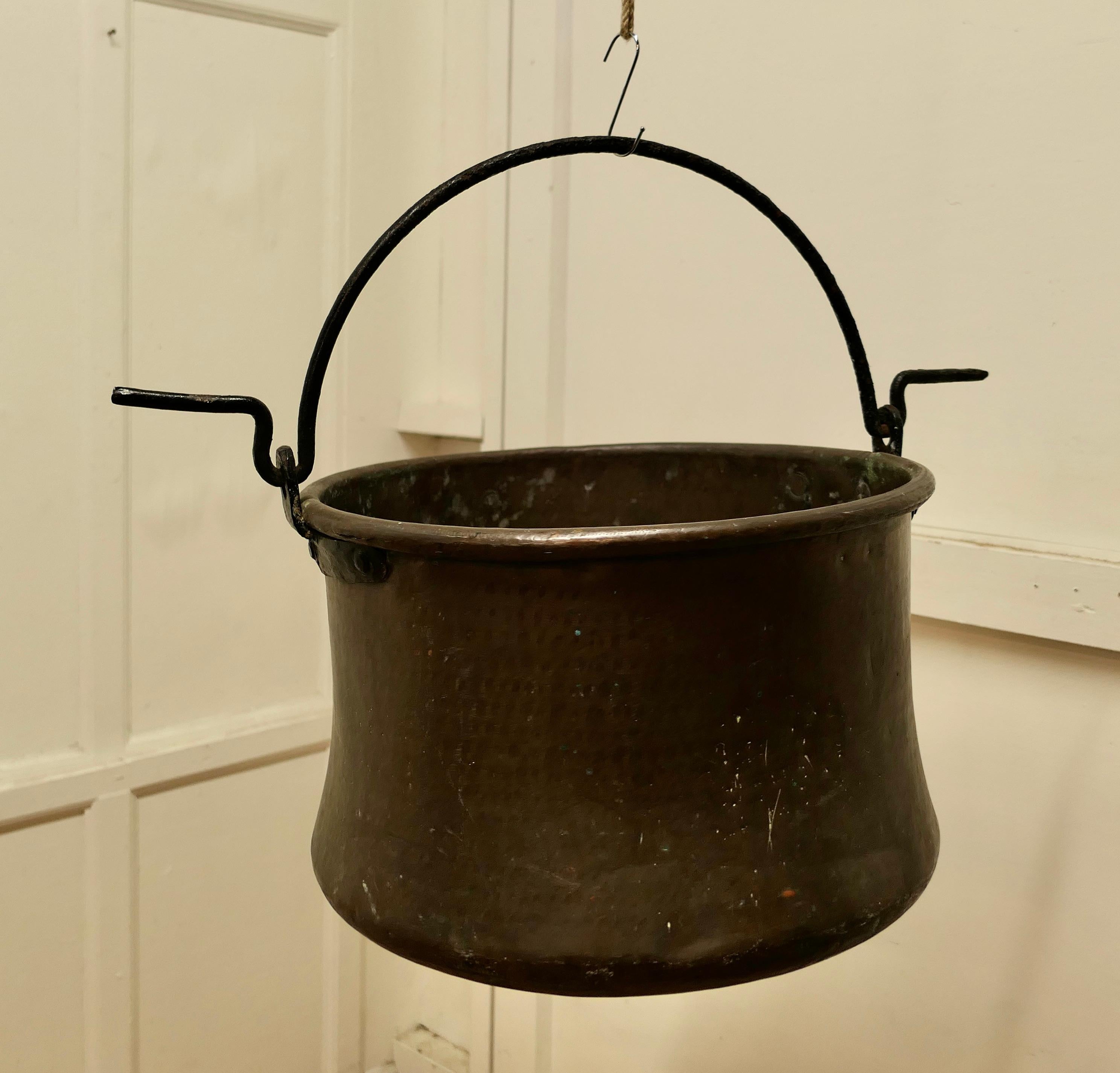 Very large 18th century brass cooking pot, Cauldron.

This is a lovely early cooking pot, it has been hand made in Brass, slightly flaring out at the bottom, to catch the maximum heat from the fire 
The pot has a rolled top.
and the Iron handle