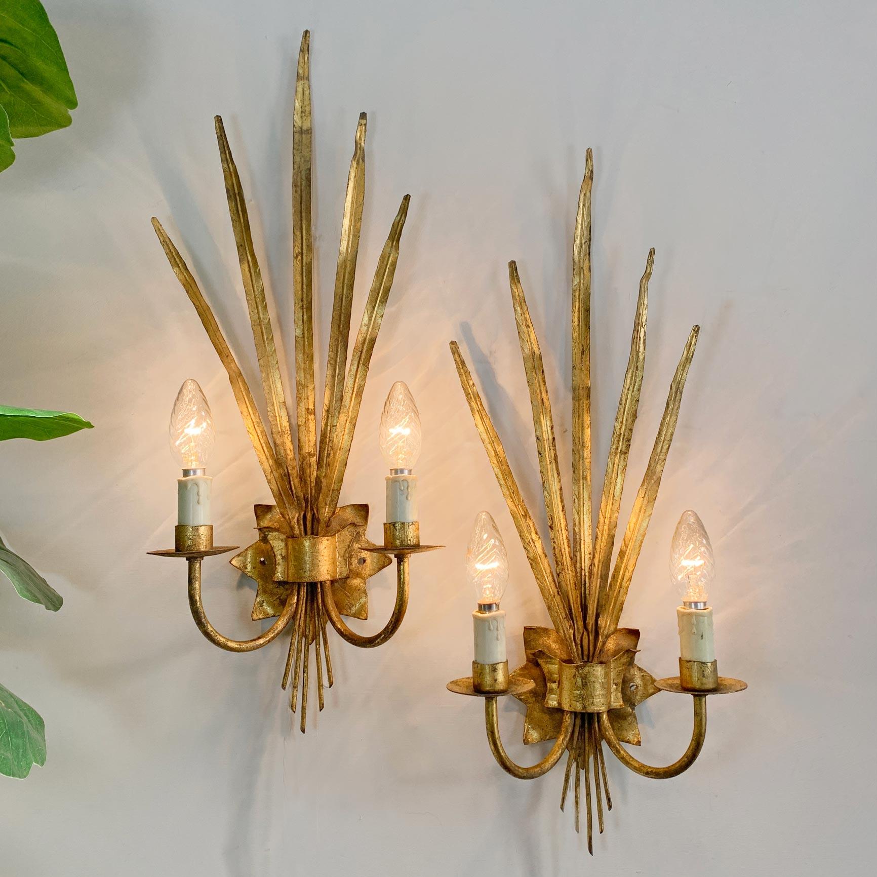 Large ‘Ferro Art’ reed leaf wall lights
Spain 1950's 
 
Fabulous pair of very large gilt wall lights in the design of elegant fine leaves
These lights are attributed to ‘Ferro Art’ 
61cm height, 23cm width, 14cm depth 
 
Each light takes 2 small