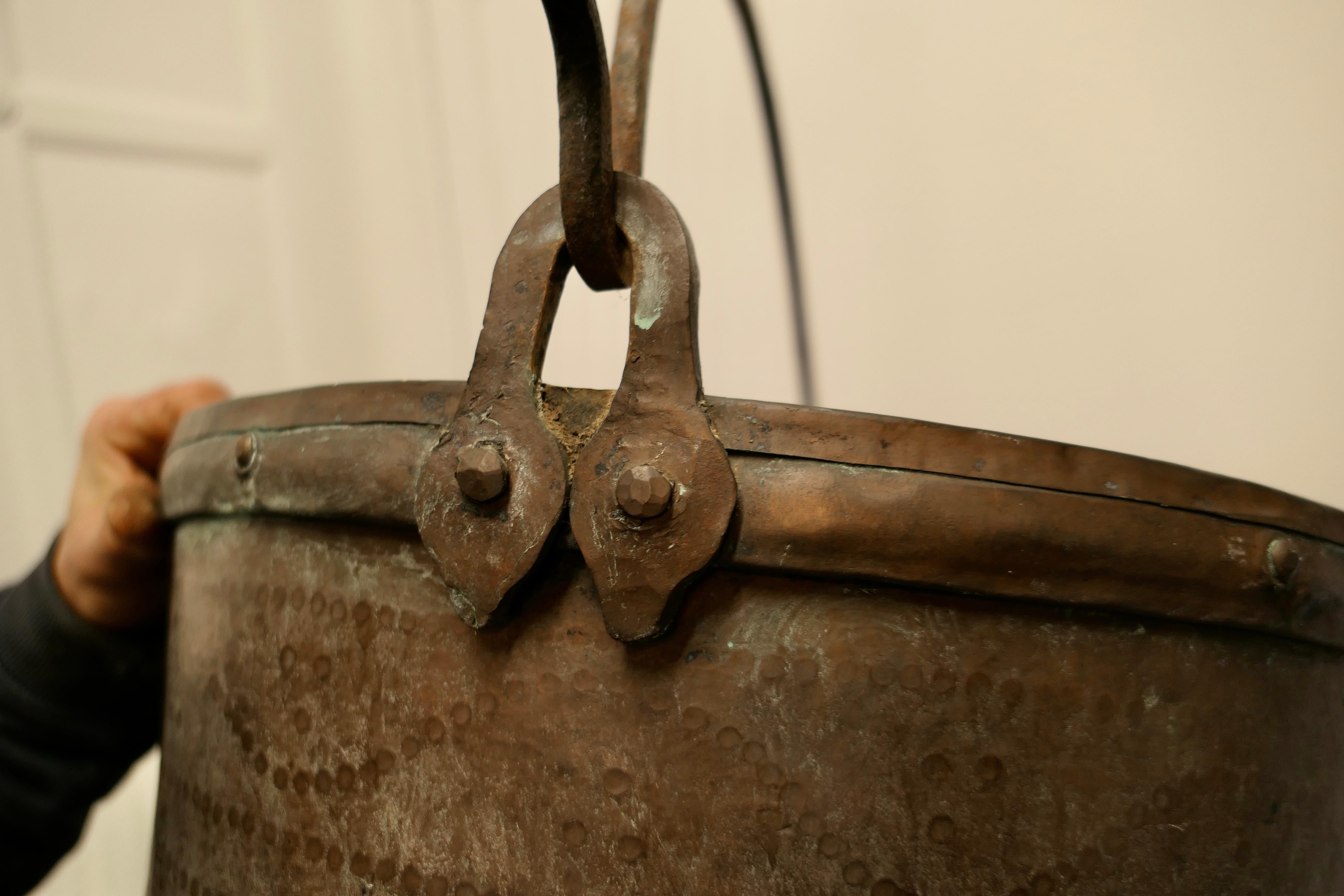 Very large 19th century copper cooking pot, Cauldron 

This is a lovely early Cooking Pot, it has been made in hand beaten Copper The pot has a rolled top and the Iron handle swings through 180 degrees
It is a very heavy sound pot with the usual
