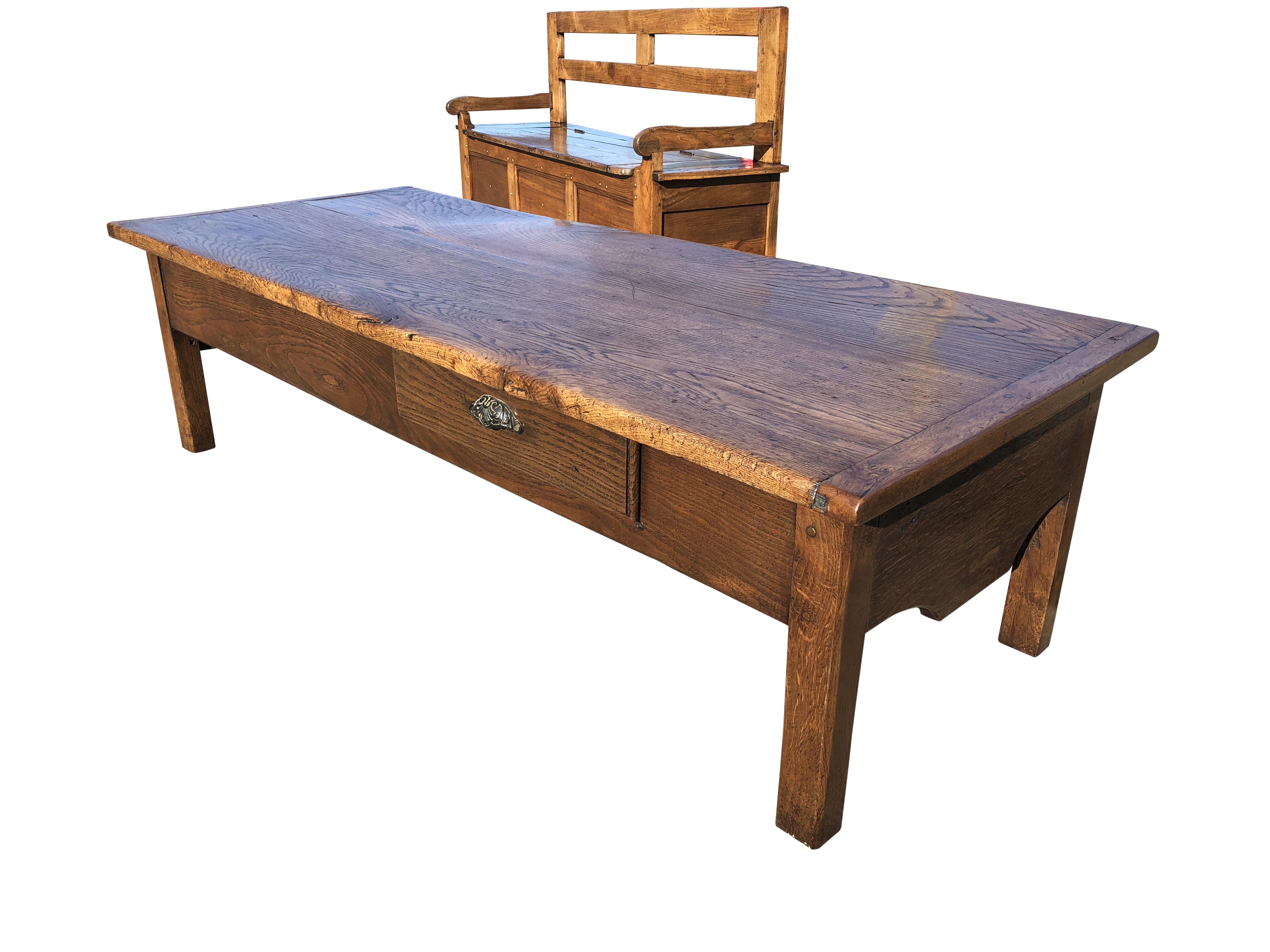 An Imposing French farmhouse oak coffee table of exceptional color and figuring with excellent storage.