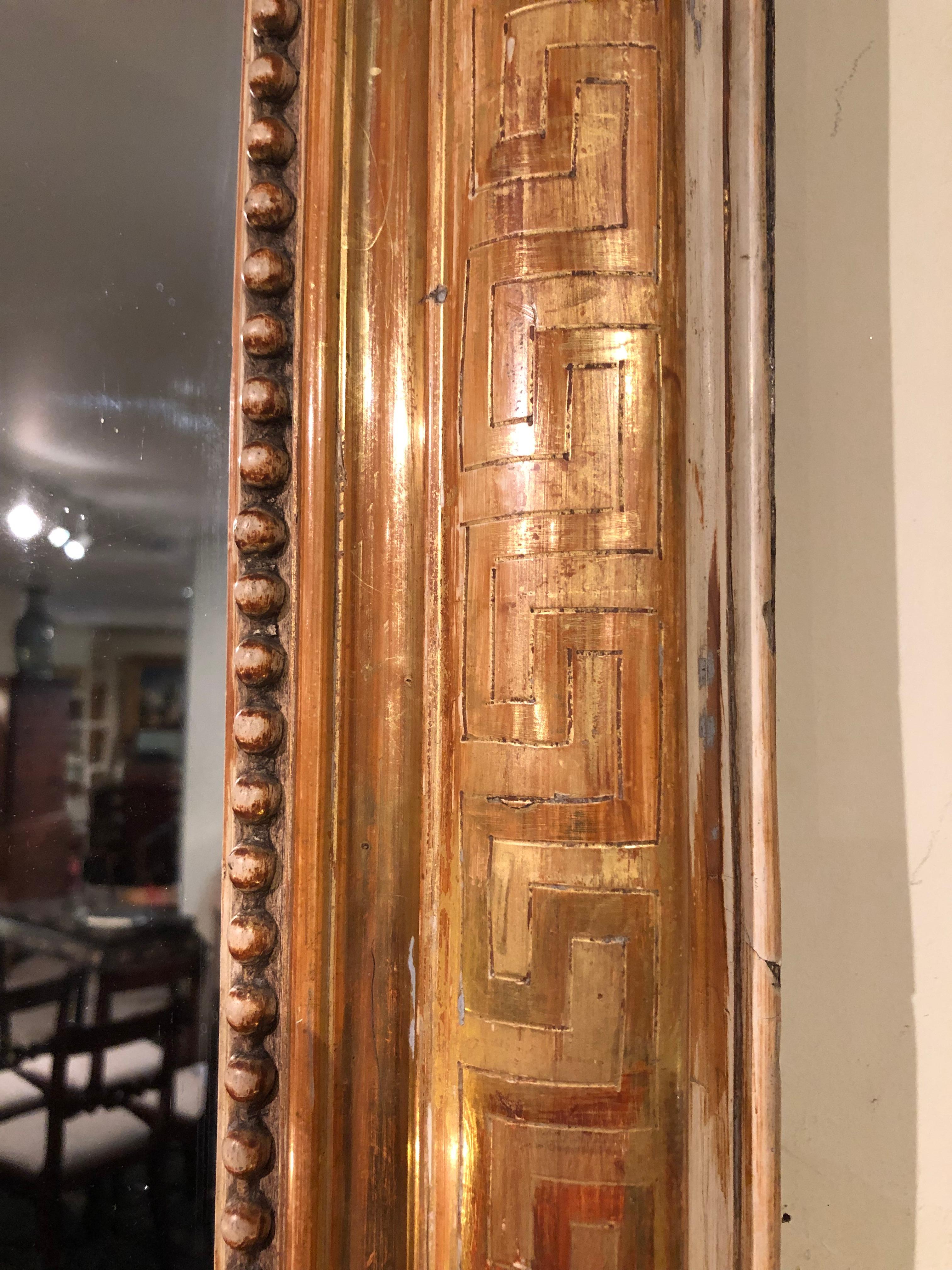 Very large 19th century gold leaf Louis Philippe mirror in excellent original condition. Very rare Greek key decoration to the frame. Original mercury glass mirror plate, with only very slight marks as shown in the photos.
