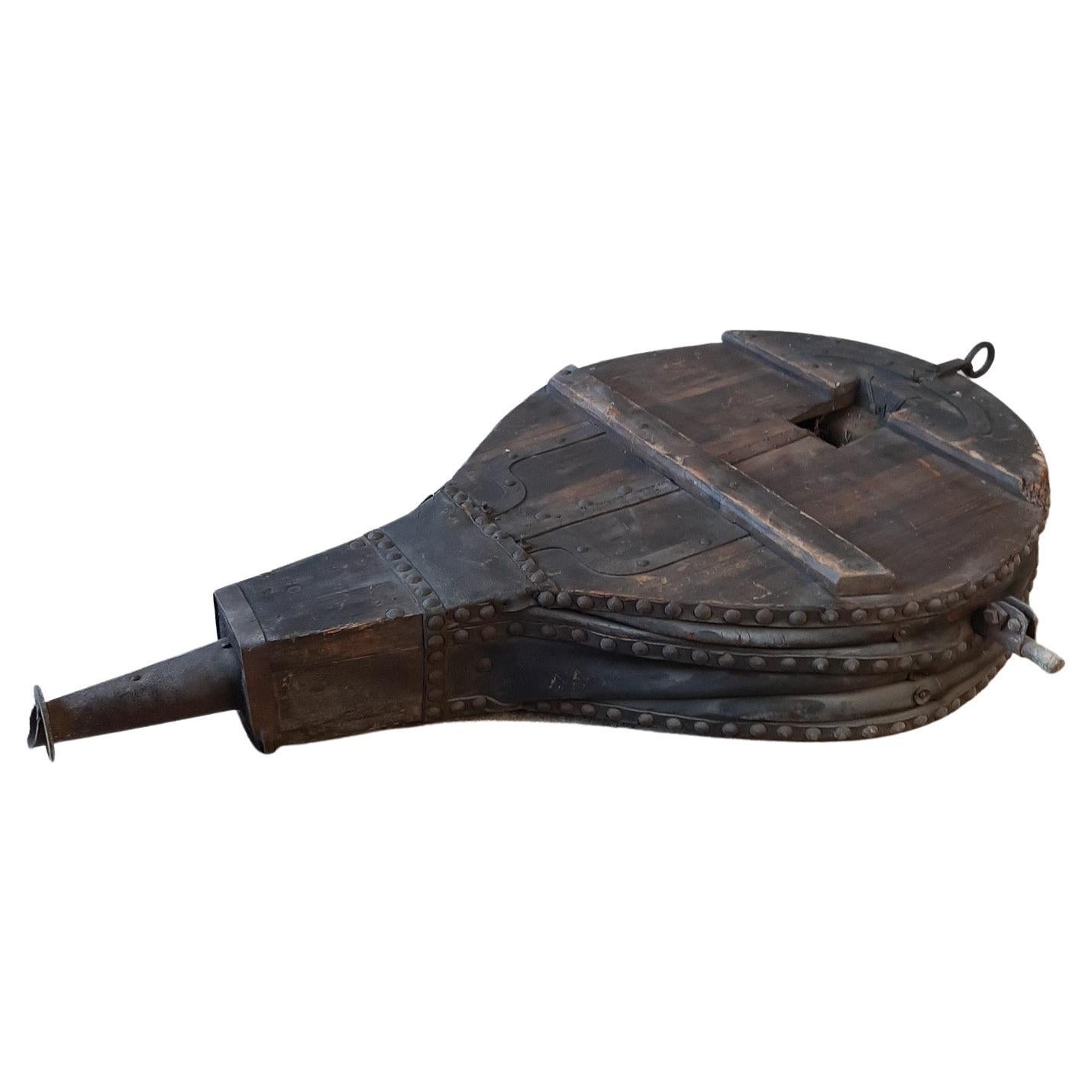 Striking 19th Century Leather, Wrought Iron, and Pine Blacksmith Bellows.

These antique XXL Bellows once fueled the fires of an old forge. Despite minor damages to the leather, they continue to operate effectively. Enhanced with a waxed finish in a