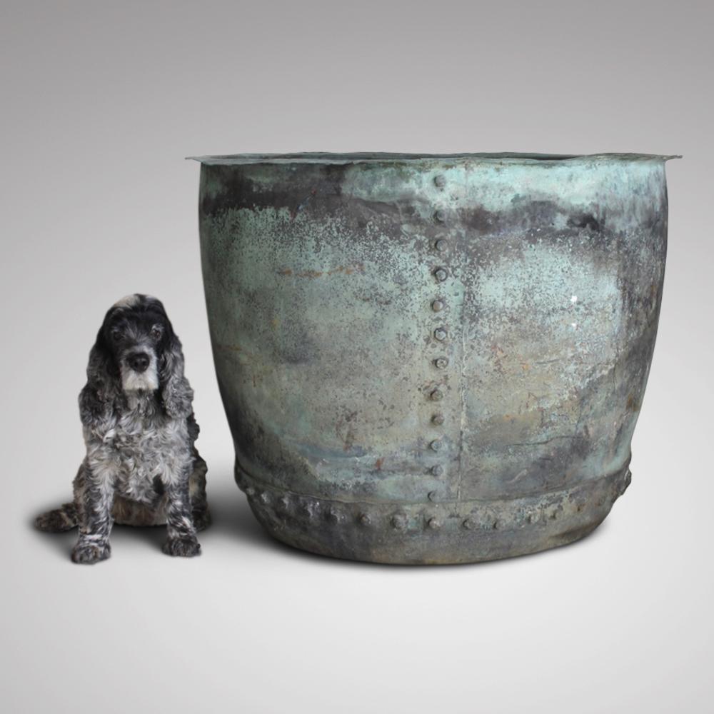 A very large, early 19th century riveted copper boiler, for use as a garden planter or log bin. In excellent condition, with the most beautiful and natural verdigris patination. No structural damage or repairs, with two drainage holes in the base,