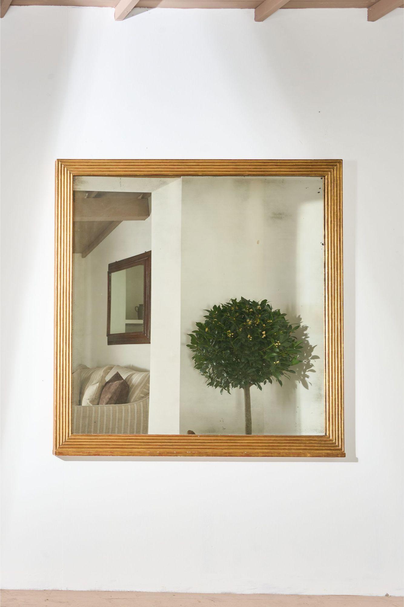 This a stunning, completely original very large square gilt overmantel mirror with reeded frame. It has an incredible foxed mirror plate offering the perfect balance of patination and usability. The scale of the mirror makes it a show stopping piece