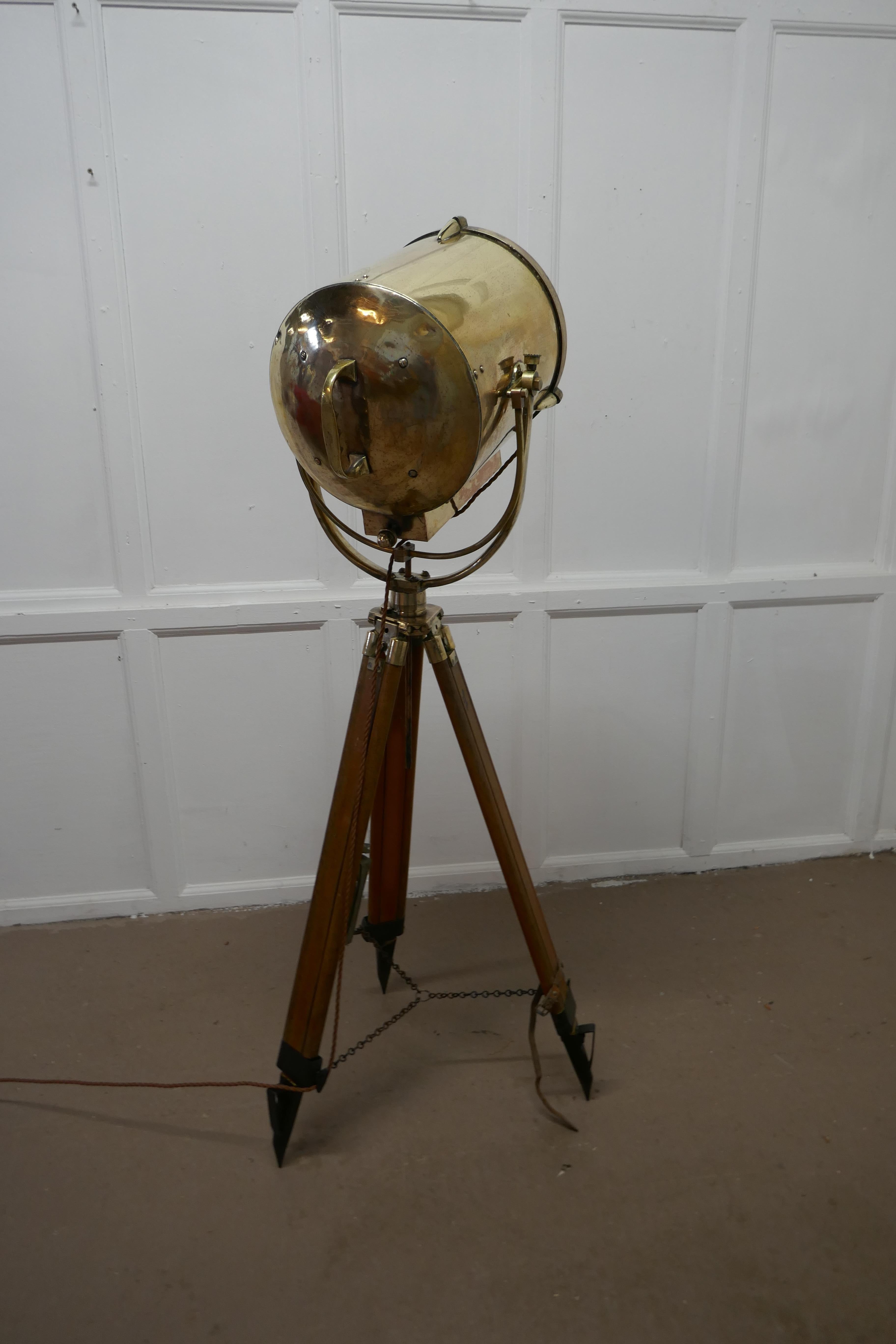 Very large 19th century vintage nautical search light or spot light by G Vieira

The Lamp is in brass it is very large and set on a wood and brass tripod, it is fully tilting and swiveling, it has makers plaque reading G Vieira Portugal 
The