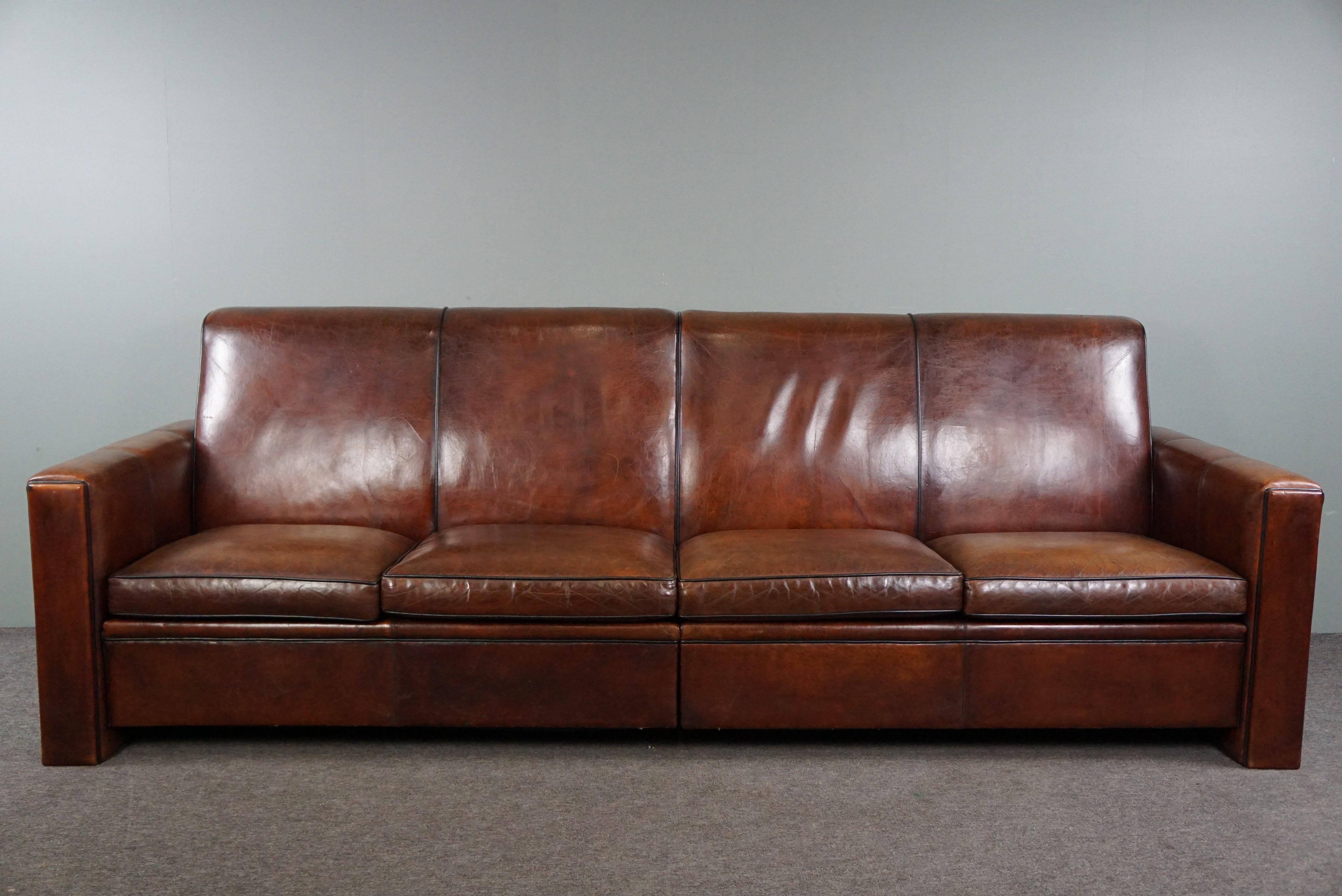 Offered is this large custom-made sheepskin leather 4-seater design sofa. We don't come across sheepskin leather sofas of this size often. That's not surprising since it was custom-made and not readily available in this size in factories. Its life