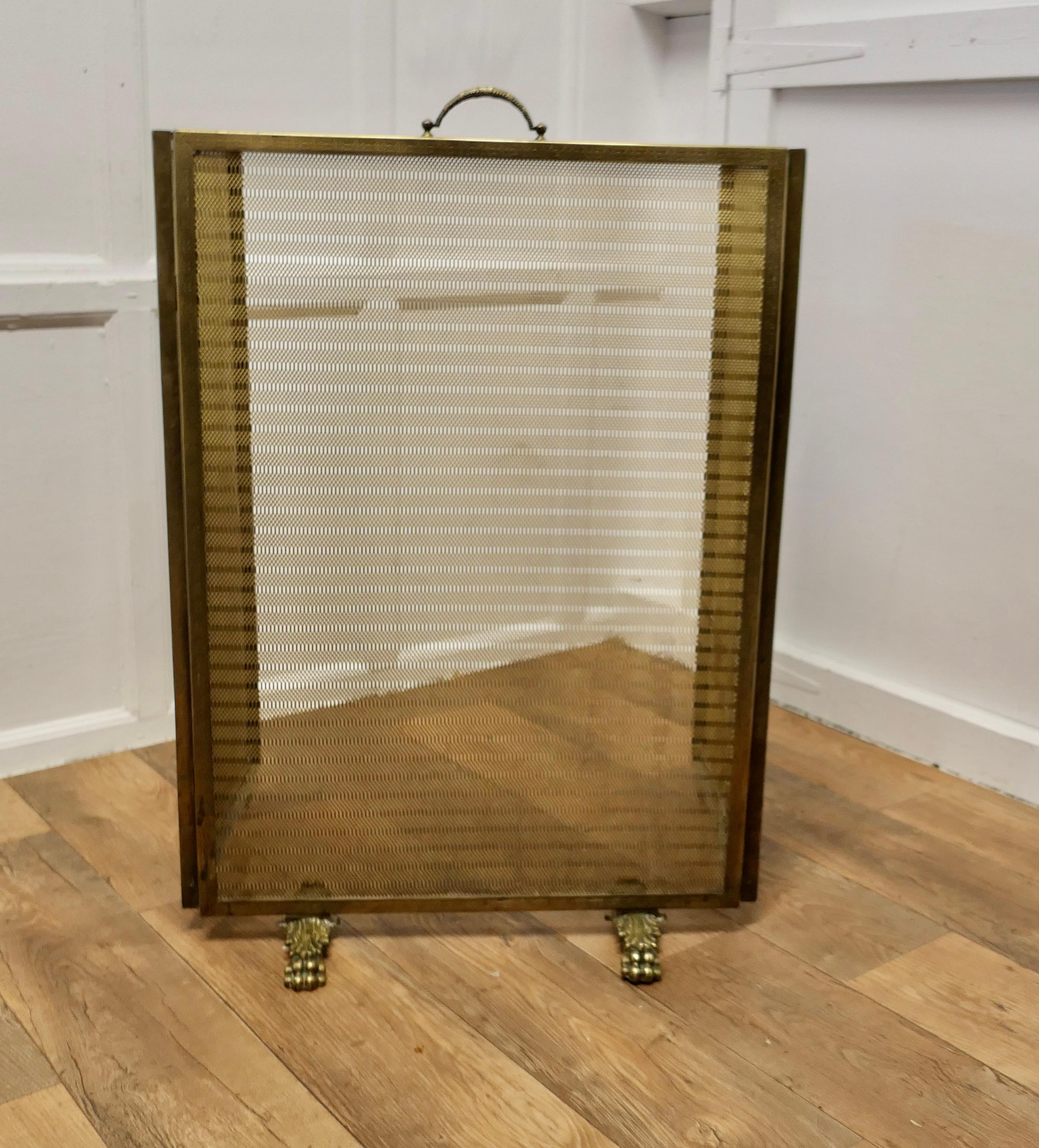 Very Large Adjustable French Chateau Brass Fire Screen/Fire Guard

This is a very large Heavy Quality Screen, it is hinged to allow the shape to be altered to fit the fire 
The guard has a decorative heavy brass mesh infill and double sided Lions