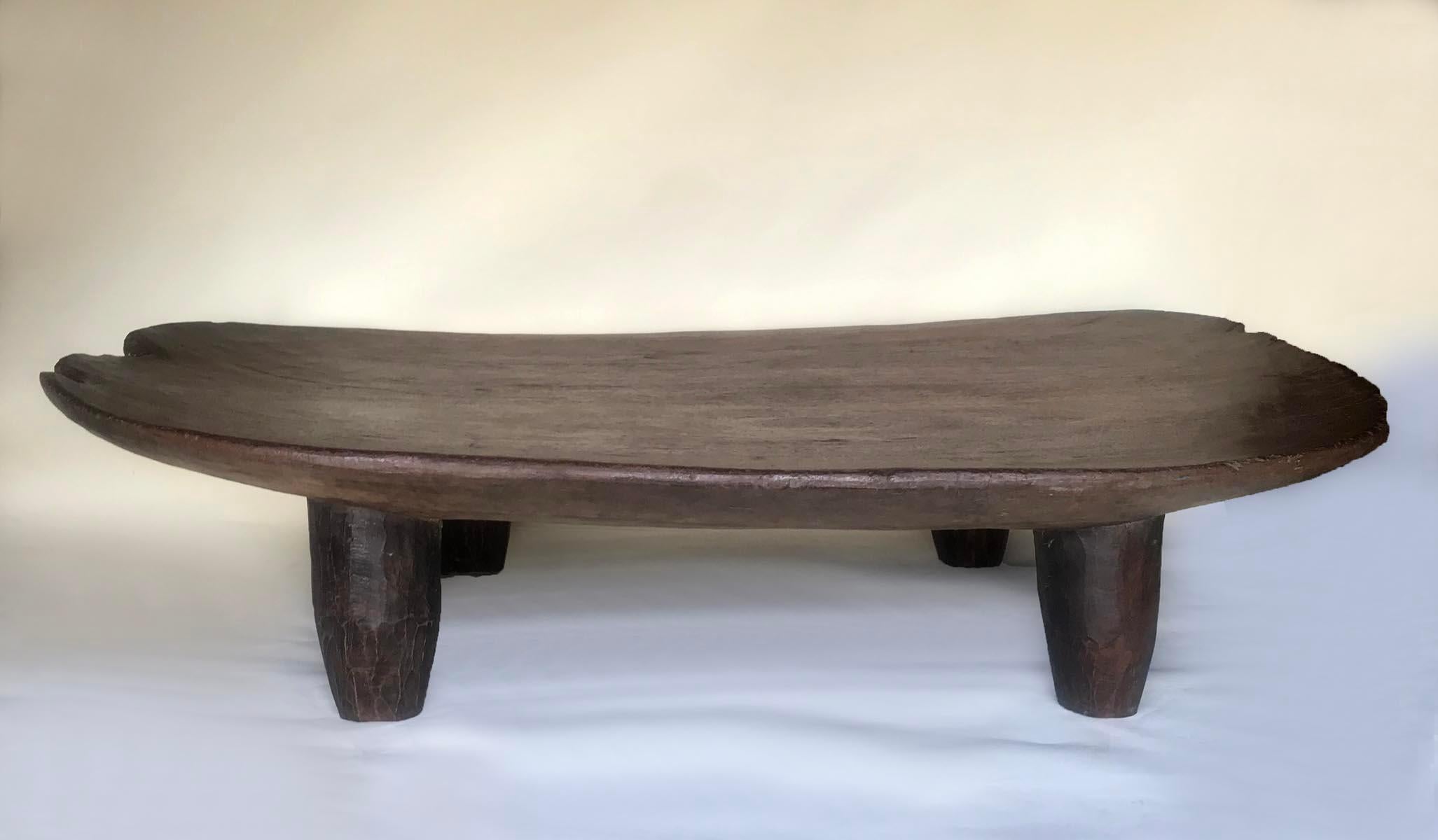Huge! Carved out of one very wide single piece of wood, this is a vintage bed from the Nupe tribe in northern Nigeria. Wonderful old patina throughout. Carved conical legs. This table would be a fantastic coffee table. Beautiful wood, smooth and