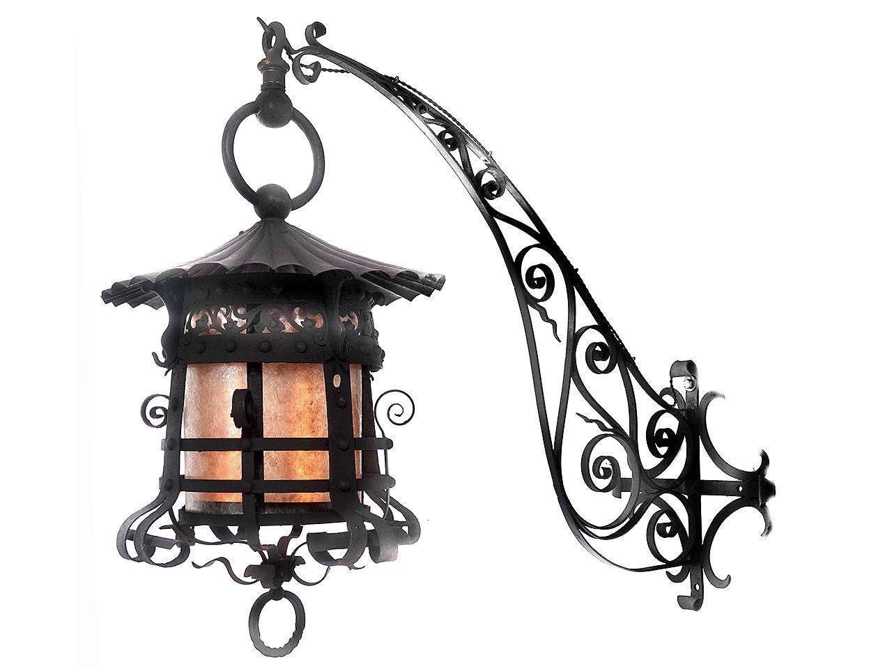 This impressive lantern is all hand-hammered and blacksmith made. The lantern alone has a 24 inch diameter and still hangs from the original wall bracket. This is the type of heavy lantern custom made for large and important estates. It has now been