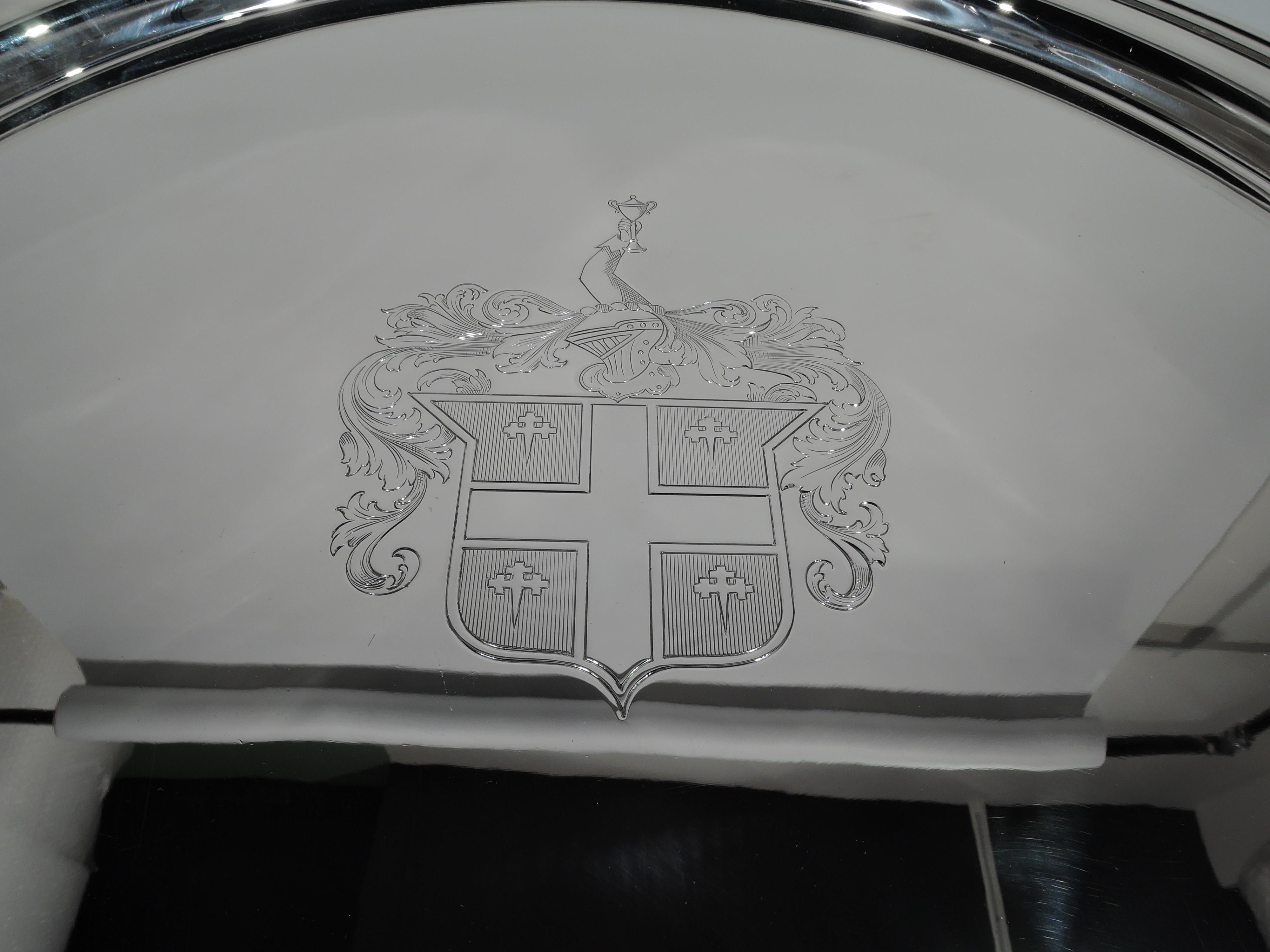 Very large and heavy sterling silver serving tray. Made by International in Meriden, circa 1950. Circular with molded rim and armorial engraved in well center. Fully marked including no. W316. Weight: 119 troy ounces.