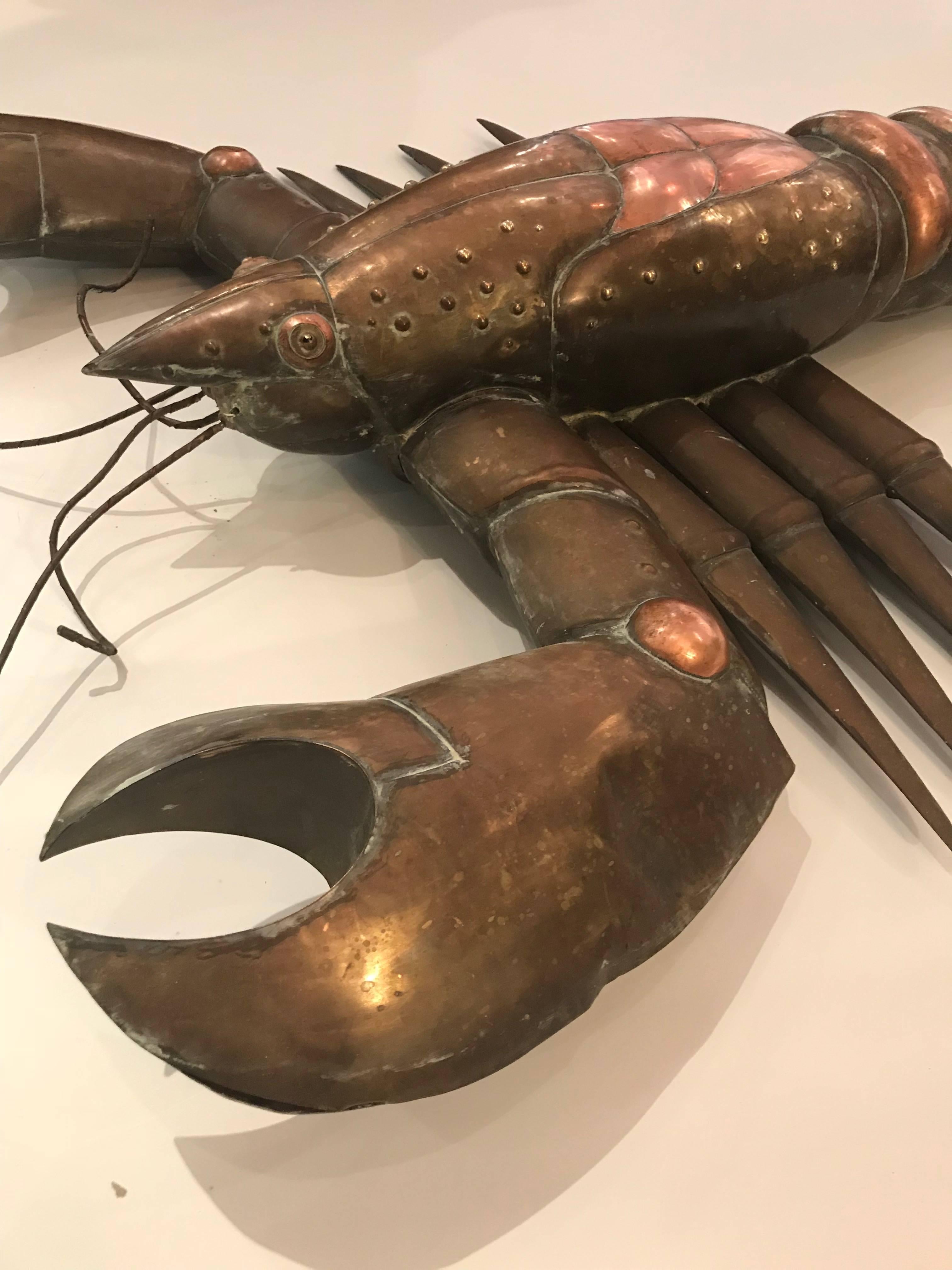 Very large and rare Sergio Bustamante brass and copper hanging lobster with glass eyes. Executed in the 1980s by the renowned Mexican artist in his hometown of Guadalajara.