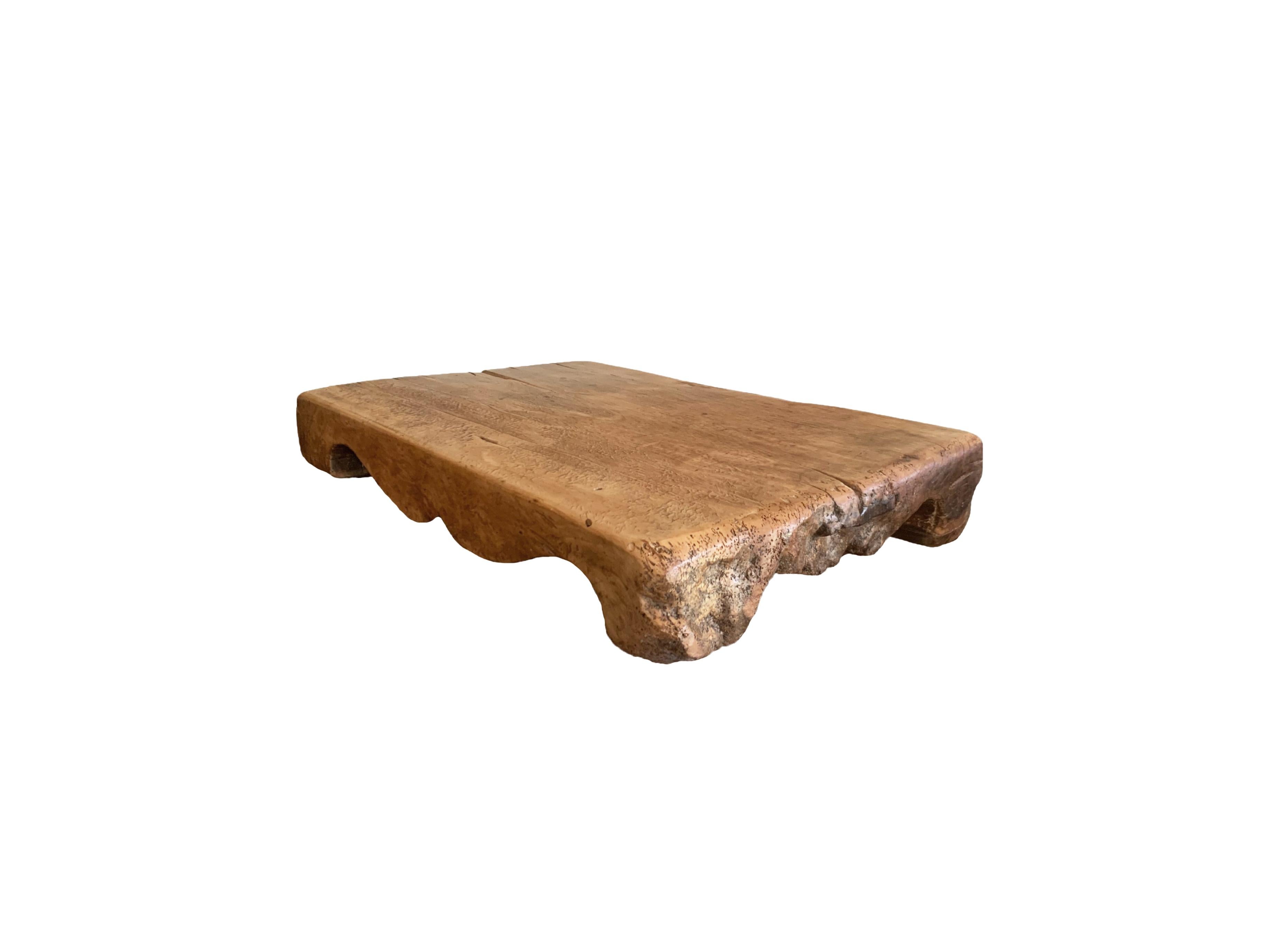 An Antique Chinese chopping block with hand-carved detailing. Two original iron supports are wedged on both sides to support such a large piece of solid wood. Made from a single block of hardwood, the block is very heavy and solid. A wonderful piece