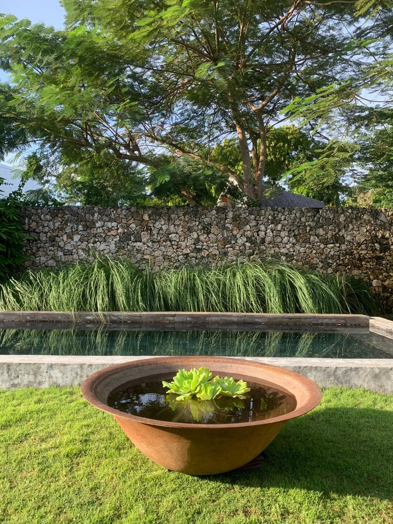 This corten steel bowl was once used to keep batik textile dyes on the island of Java. A wonderfully sculptural object with a weathered faded texture. In the modern day this makes for a wonderfully spacious planter, garden water bowl or even as an