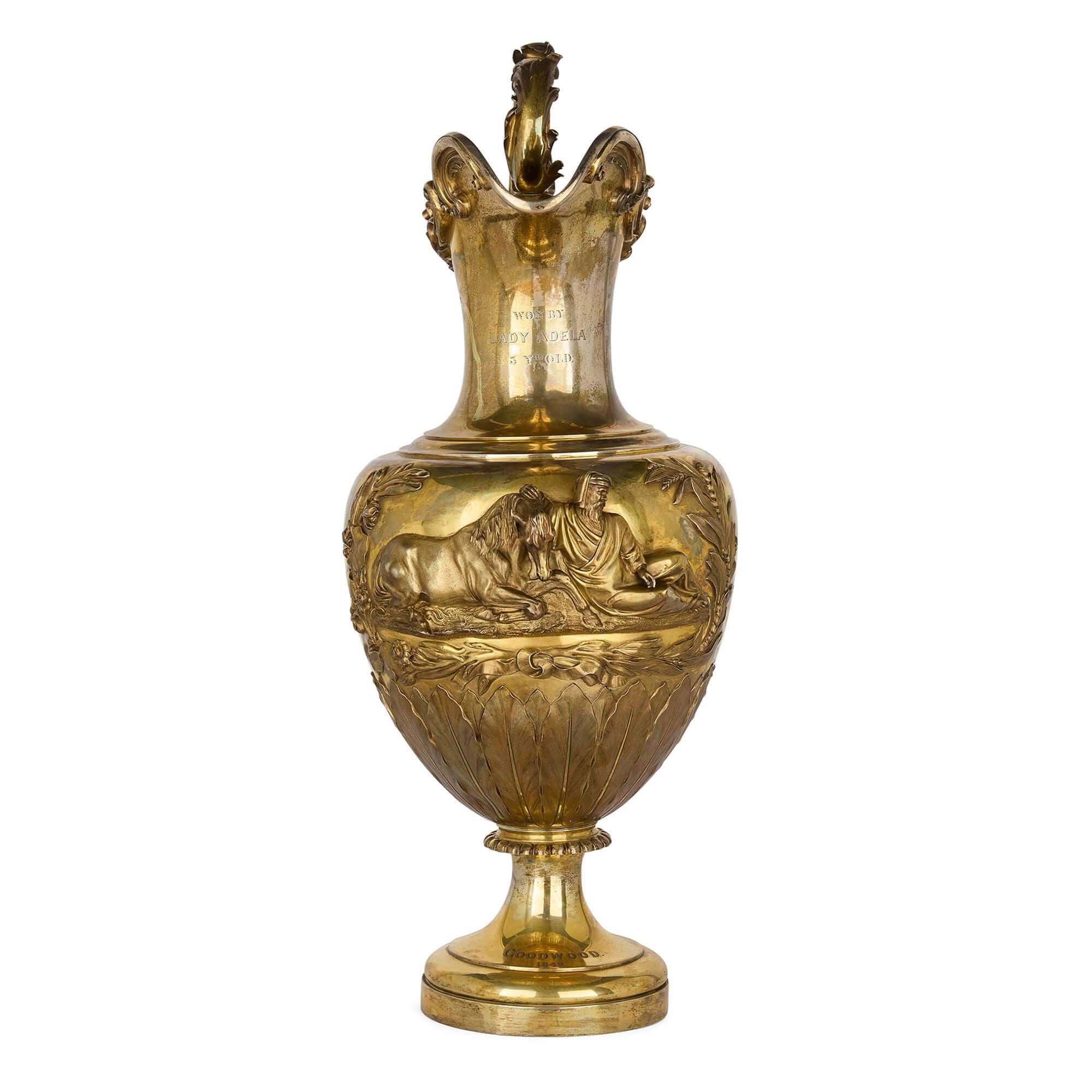 Very large antique English silver-gilt equestrian trophy by Paul Storr 
English, 1837
Jug: Height 87cm, width 45cm, depth 36cm
Case: Height 93cm, width 52cm, depth 38cm
Weight 9kg

Presented as a prestigious prize for the Goodwood Stewards’ Cup in