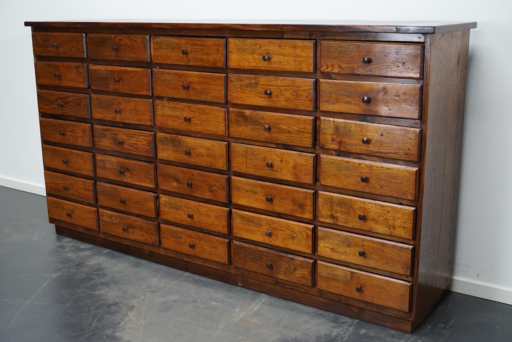 This oak apothecary cabinet with brass hardware was made in the early 20th century in France and was used in a hardware store. It is very well made and it remains in a good restored condition. The interior dimensions of the drawers are: D W H 40 x
