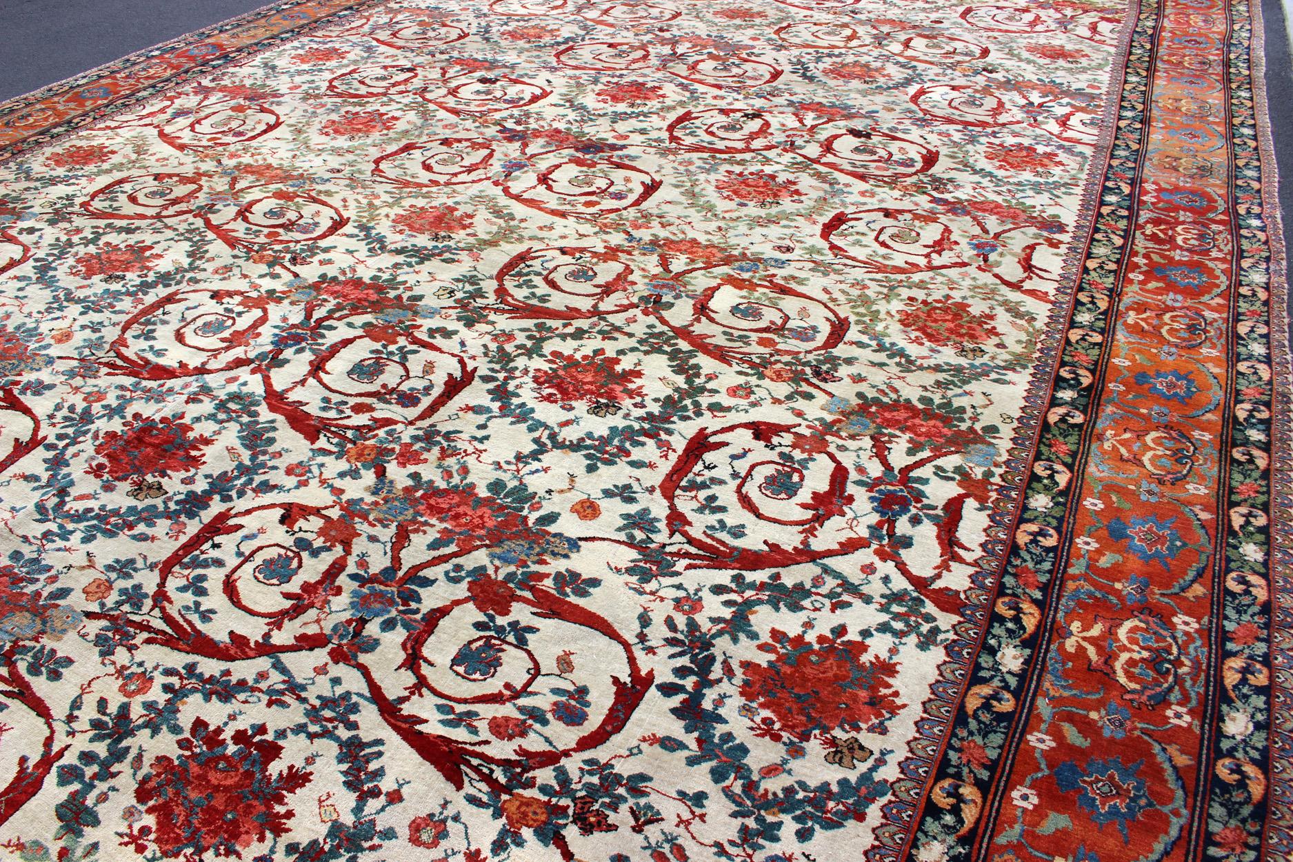 Palace sized antique Persian Bidjar carpet in ivory background and array of beautiful, and brilliant colors. Rug / TRA-170301. Country of Origin: Persia/Iran.

Measures:   14' 10