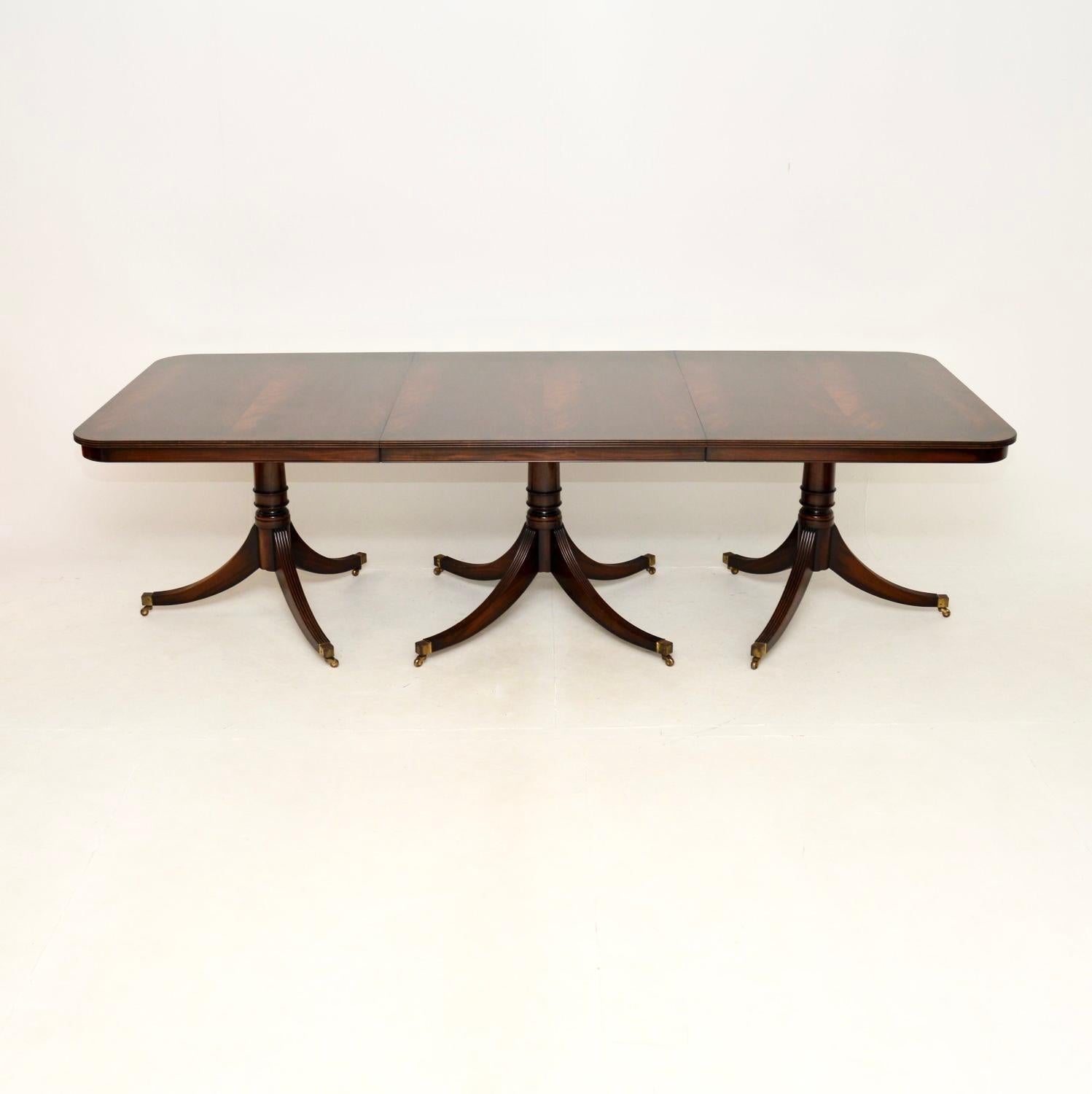 An extremely well made and very large antique Regency style extending dining table. This was made in England, it dates from around the 1950’s.

The quality is exceptional, this is very large and impressive, made to seat fourteen comfortably and