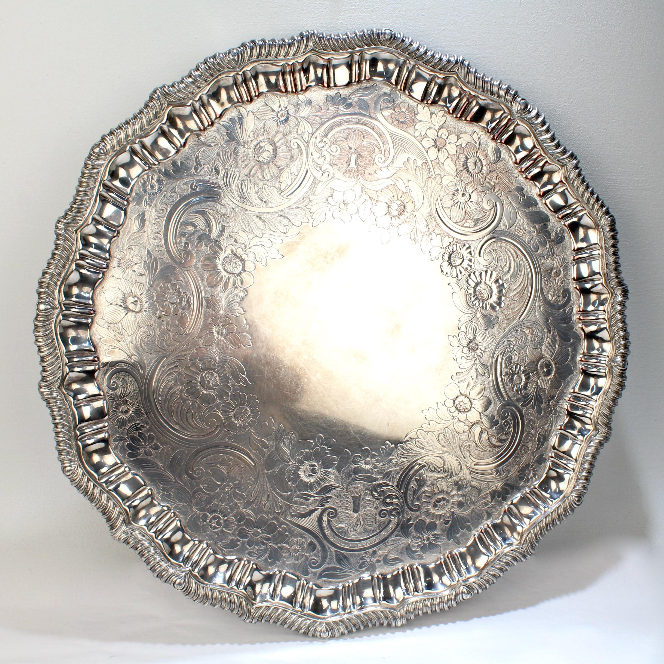 A very large, Victorian period Sheffield silver plate salver. 

With a gadrooned piecrust rim, richly engraved center, and ornate bracket feet.

Provenance: By repute, from the estate of Catherine Spencer Eddy Beveridge (who was a Socialite and
