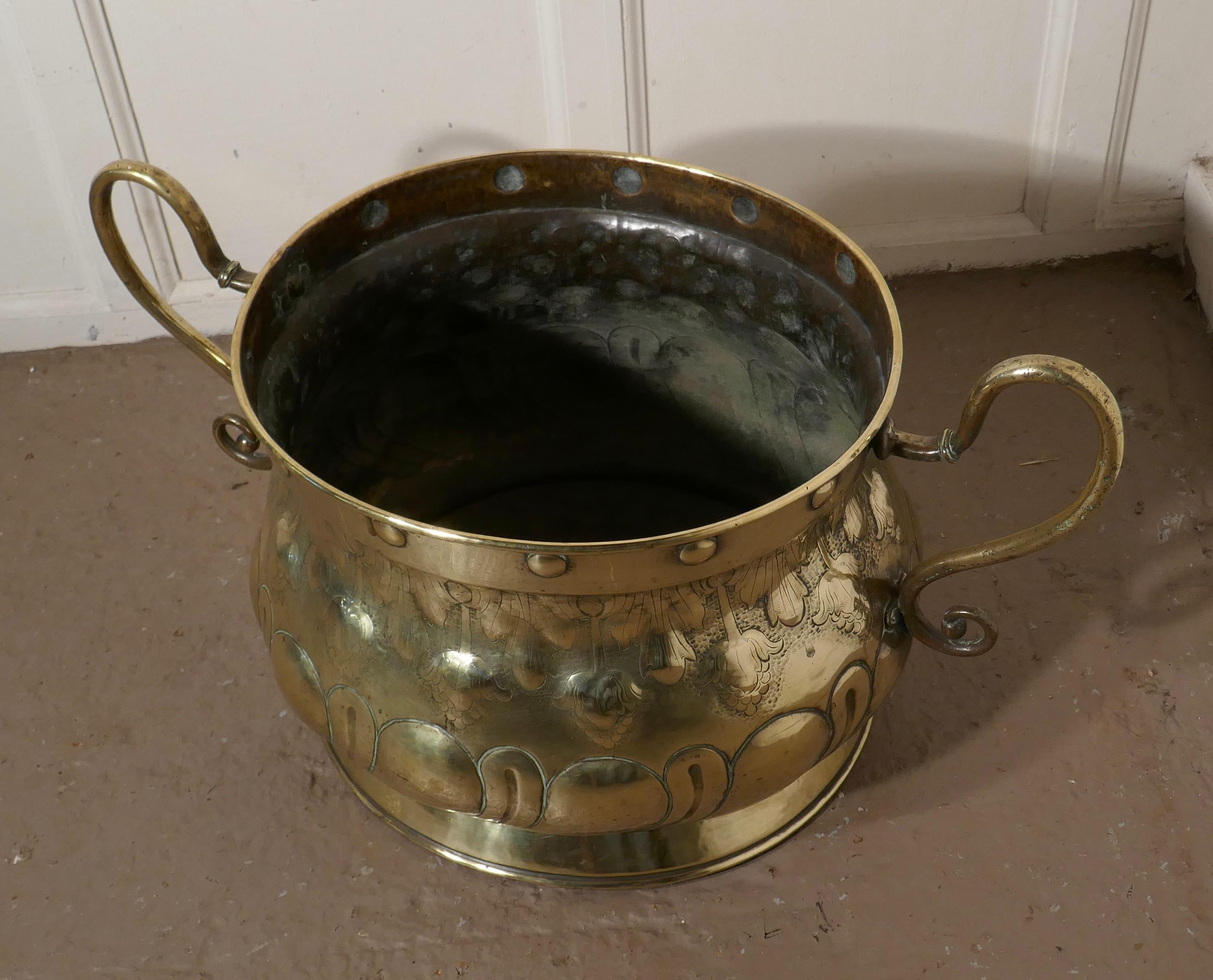 Very large Art Nouveau brass jardinière

A very large piece, big enough for the Christmas tree and a great looker
The pot id oval and is made in brass with a beaten Art Nouveau design, and huge san neck handle son each side
In very good