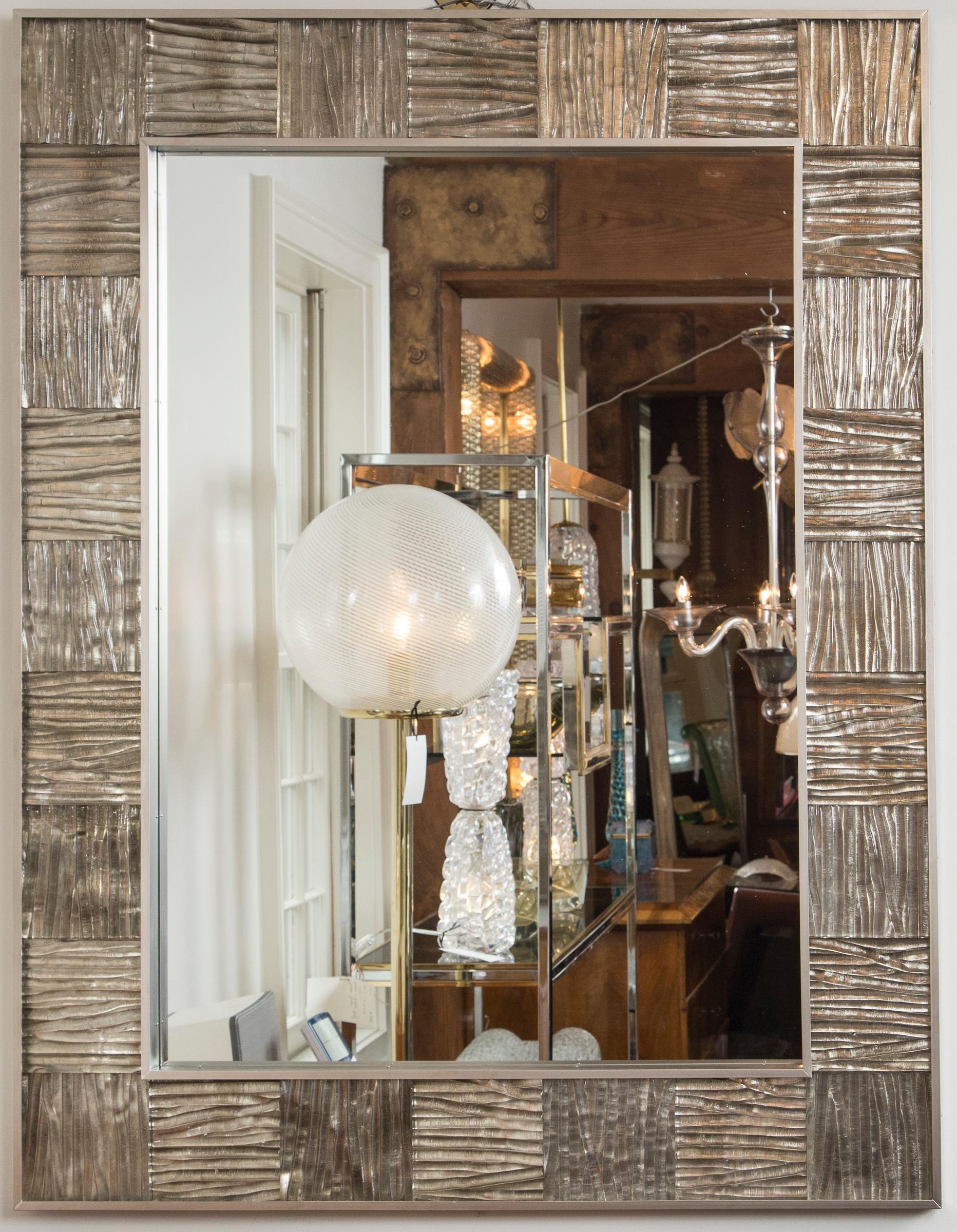 Striking matte nickel on brass framed mirror inset with thickly blown wavy textured glass panels in a clear color and finished with a champagne gilt backing, artisan metal and glass work. Weight 100 lbs
Date: Contemporary
Origin: Italy
Condition: