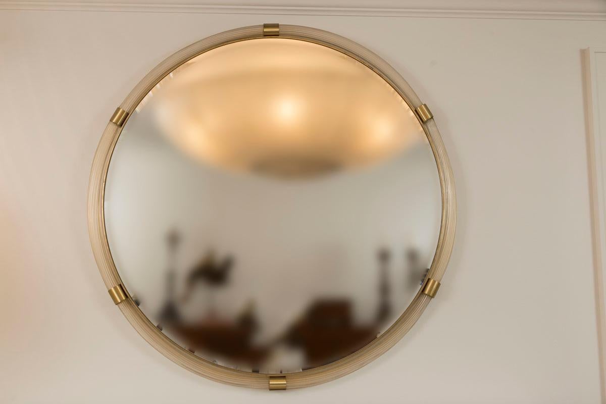 Murano glass blown 23k gold transparent  reeded tubes joined by 5 unlacquered brass fittings to form a lovely circular mirror with beveled looking glass, comprised of solid wooden backs and ready to hang

Origin: Murano, Italy

Condition: Very