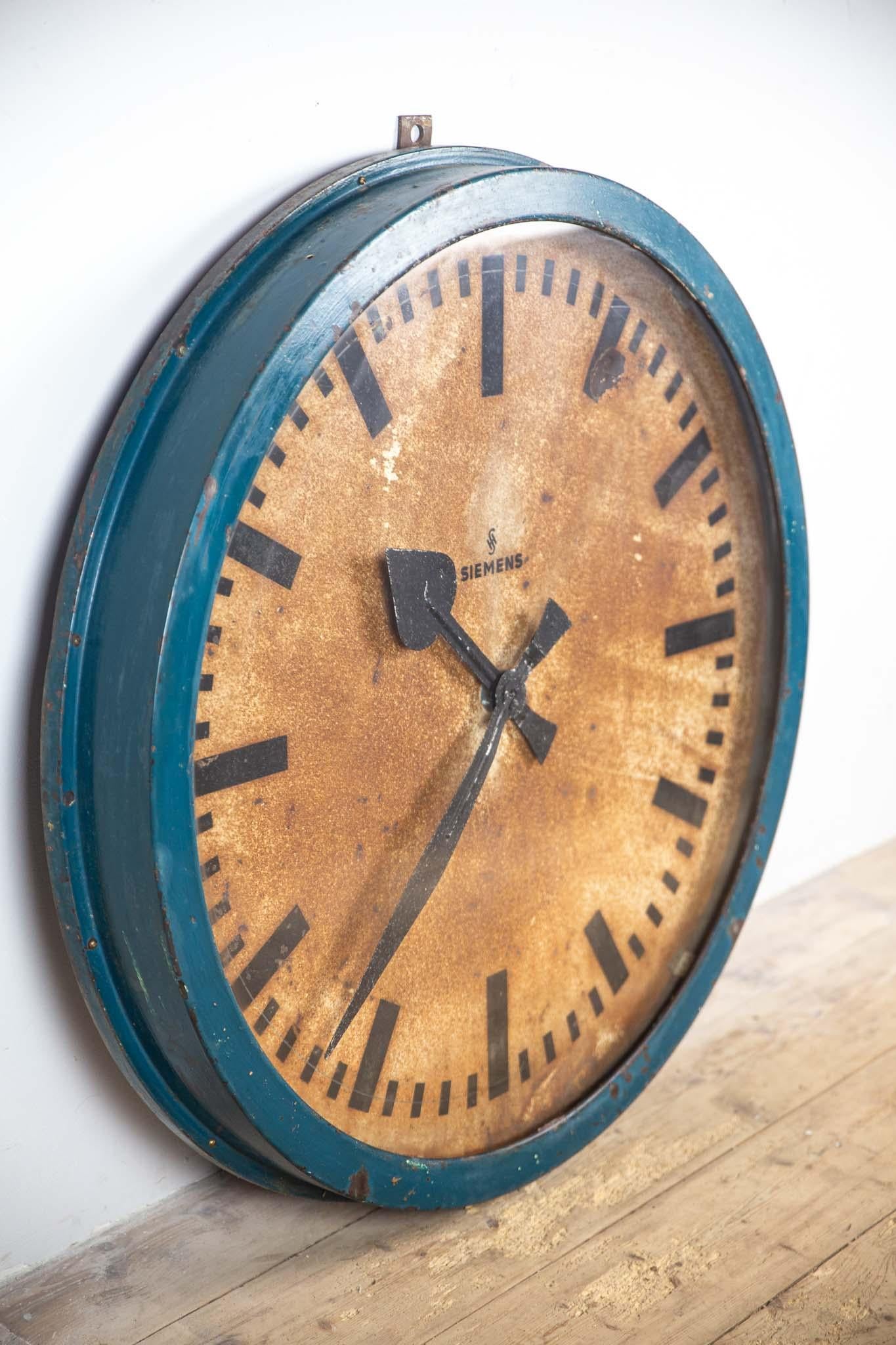 This beautiful, unique wall clock originates from an old cable factory in former East Germany (DDR). The clock once hung in the hall where workers could keep track of the time. It has a diameter of 95 cm, features new glass, and the original