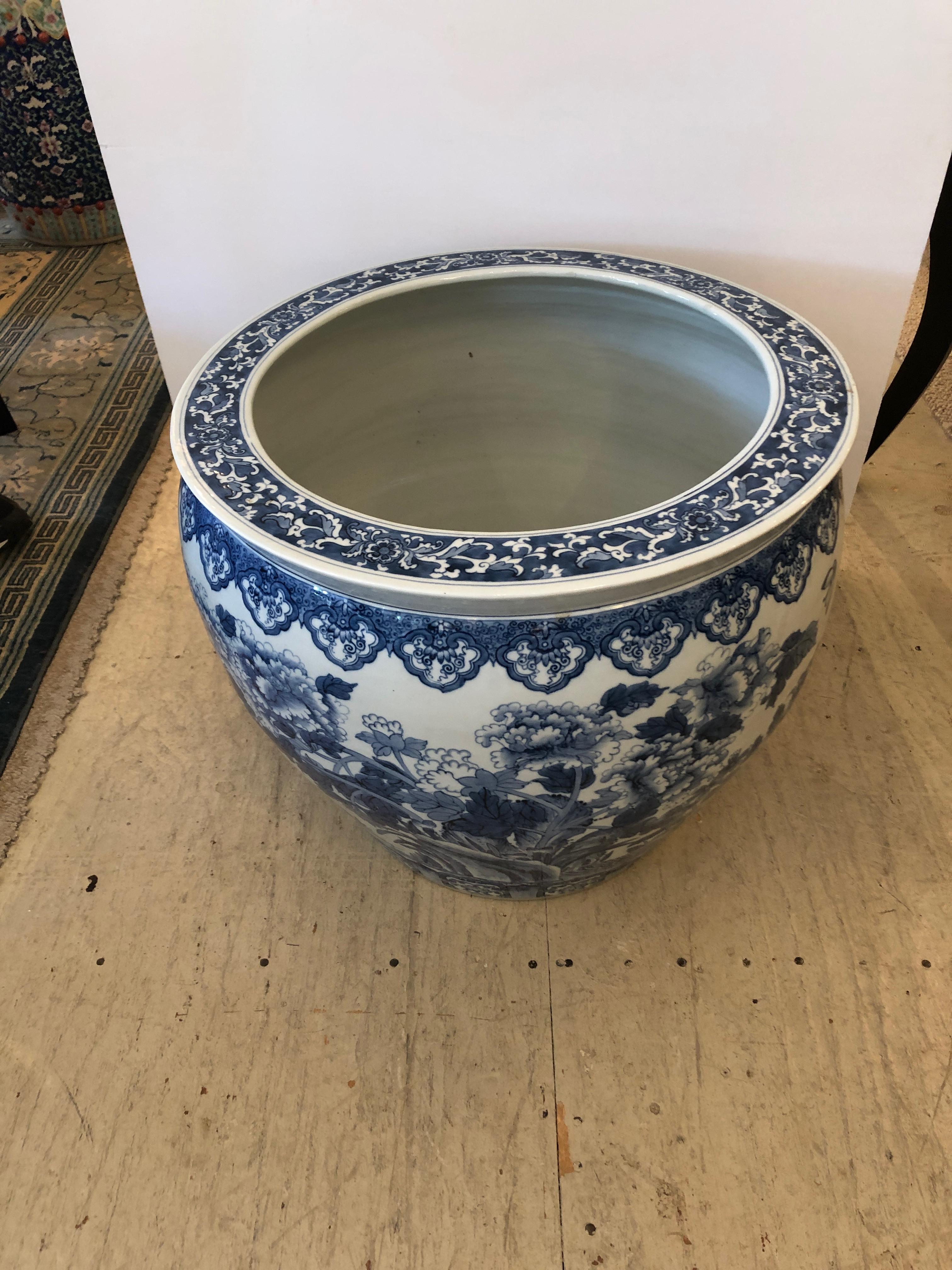 A big gutsy heavy Chinese ceramic planter having beautiful blue and white decoration. Perfect size to use as a base for a coffee table if you top it with a round piece of glass.
