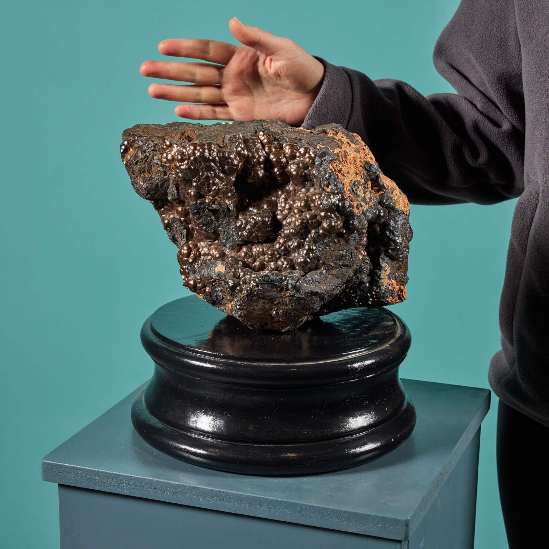 A very large, naturally occurring botryoidal hematite specimen, presented on one of our exclusive painted plaster display plinths.

Hematite is the most important iron ore; in fact, iron makes up 70% of its composition. Its appearance can vary
