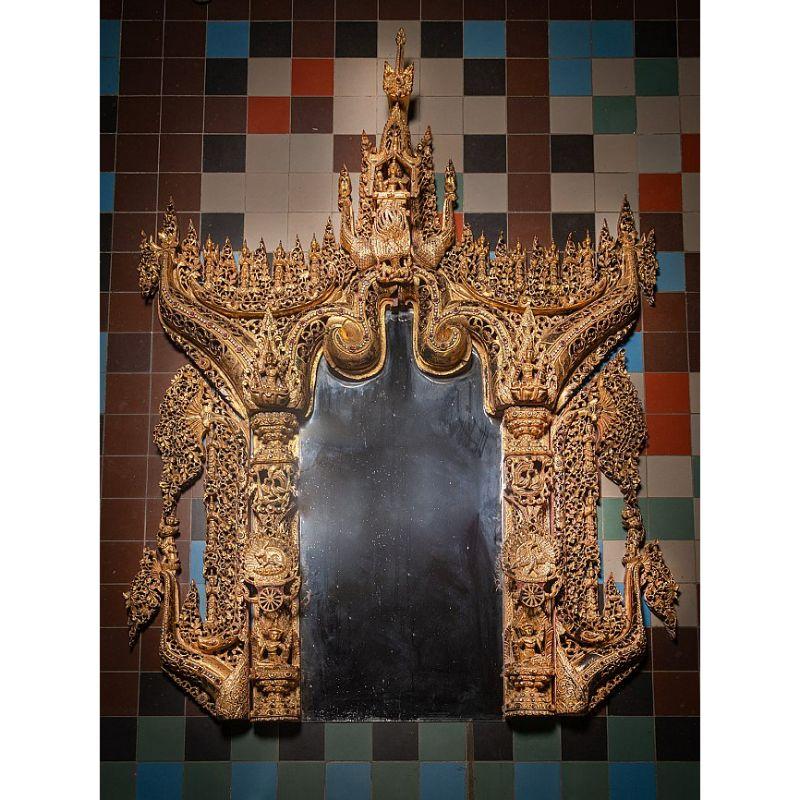Material: wood
247 cm high 
185 cm wide and 20 cm deep
Gilded with 24 krt. gold
Mandalay style
Originating from Burma
19th century
Was shipped to europe in the middle of the 20th century
9 seperate parts - with a new mirror
Was once the