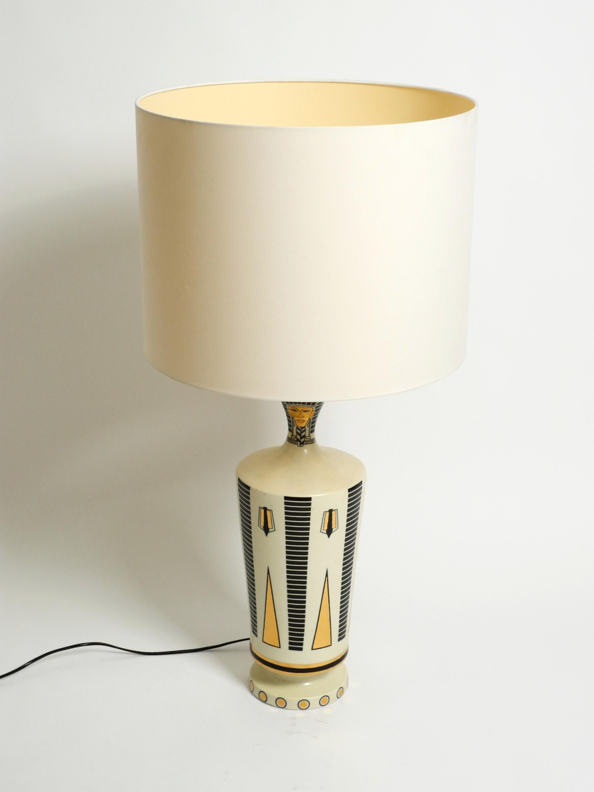 Beautiful, very large ceramic table lamp. Designed by Nicolas Blandin, Paris. Made in France.
Stunning French design with Egyptian motifs in gold and black.
Absolutely undamaged. No chips or cracks on the ceramic.
100% original condition.
The large