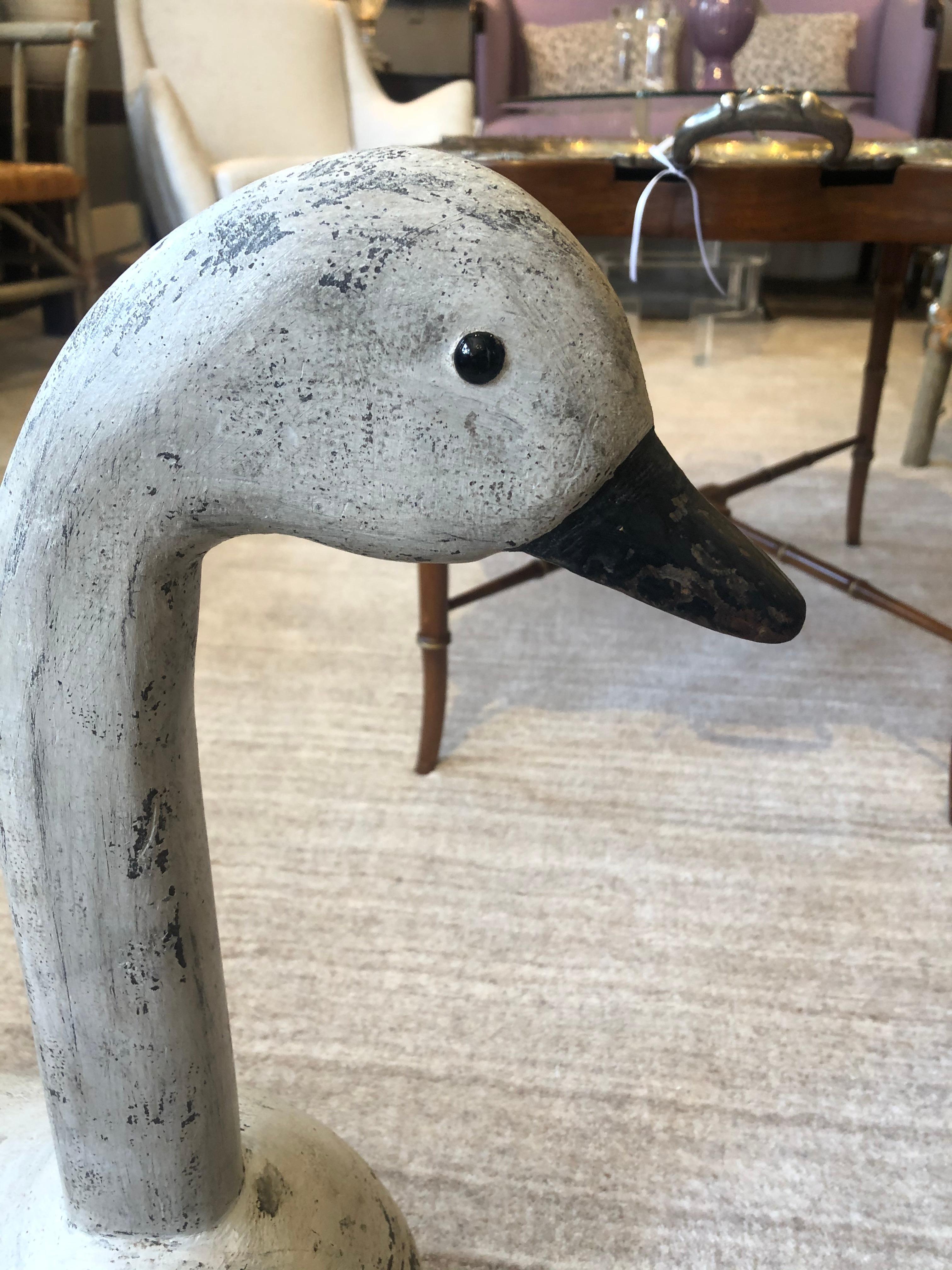Classic country Folk Art swan decoy of impressive scale, made of painted carved wood and having a wonderful aged patina.